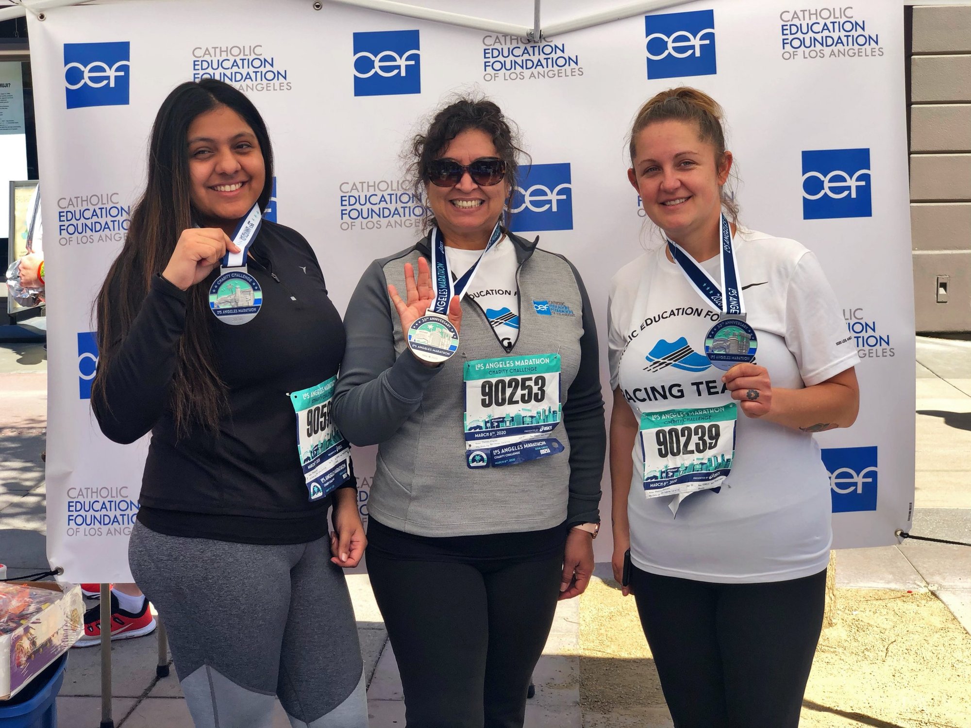 Theresa Fragoso (center) with Shannon Feldmann (right), a teacher at Bishop Conaty Loretto High School, and a former CEF employee at the finish line of the 2020 LA Marathon. (CEF)