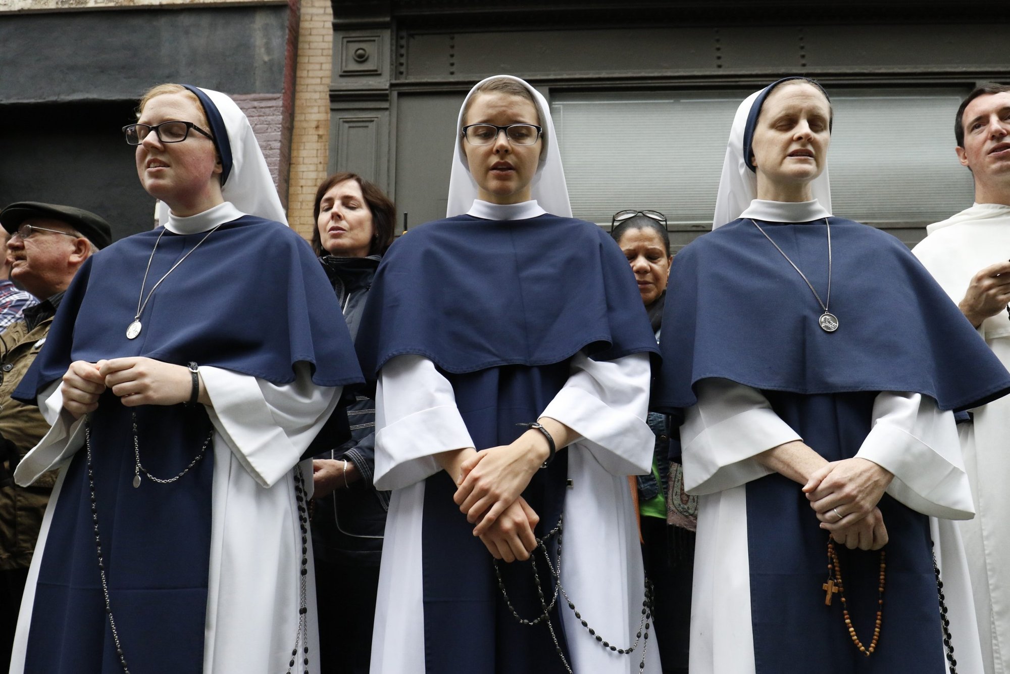 Members of the Sisters of Life join other pro-life advocates in reciting the rosary during a monthly "Witness for Life" prayer vigil held across the street from a Planned Parenthood center in New York City. (CNS photo/Gregory A. Shemitz)