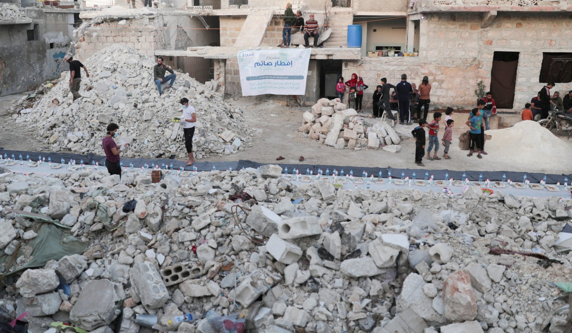 Volunteers are seen in early May preparing meals in a damaged neighborhood in Aleppo, Syria. Ambassadors to the Vatican from around the world were called together Oct. 15, 2020, to hear from Cardinal Mario Zenari, apostolic nuncio to Syria, about the humanitarian disaster in Syria. (CNS photo/Khalil Ashawi, Reuters)