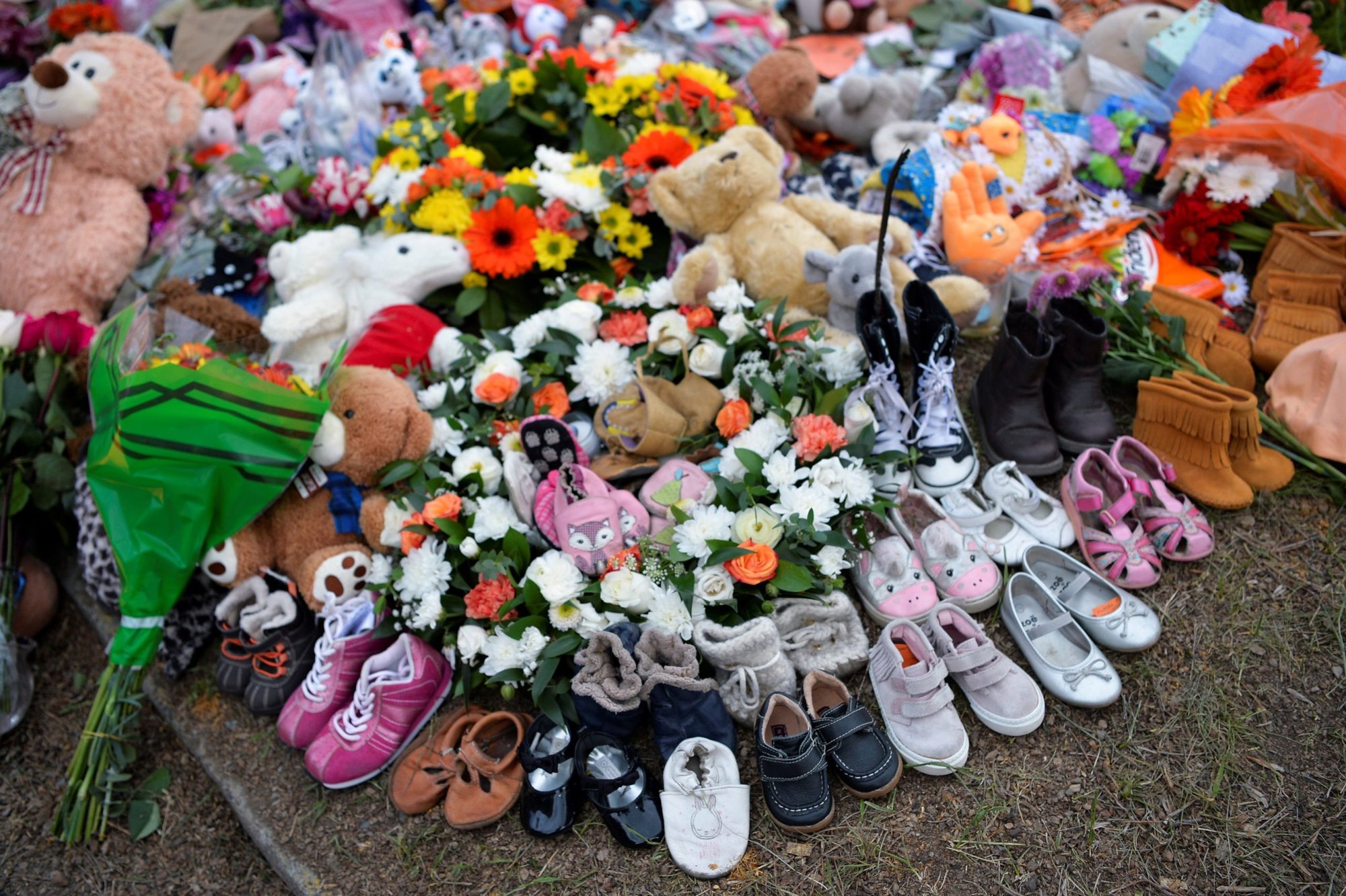 Children's shoes line a memorial on the grounds of the former Kamloops Indian Residential School June 6, 2021. More than two dozen Indigenous delegates, accompanied by a handful of Canadian bishops, plan to meet with Pope Francis at the Vatican March 28-April 1, and the residential school system is expected to figure prominently in discussions. (CNS photo/Jennifer Gauthier, Reuters)