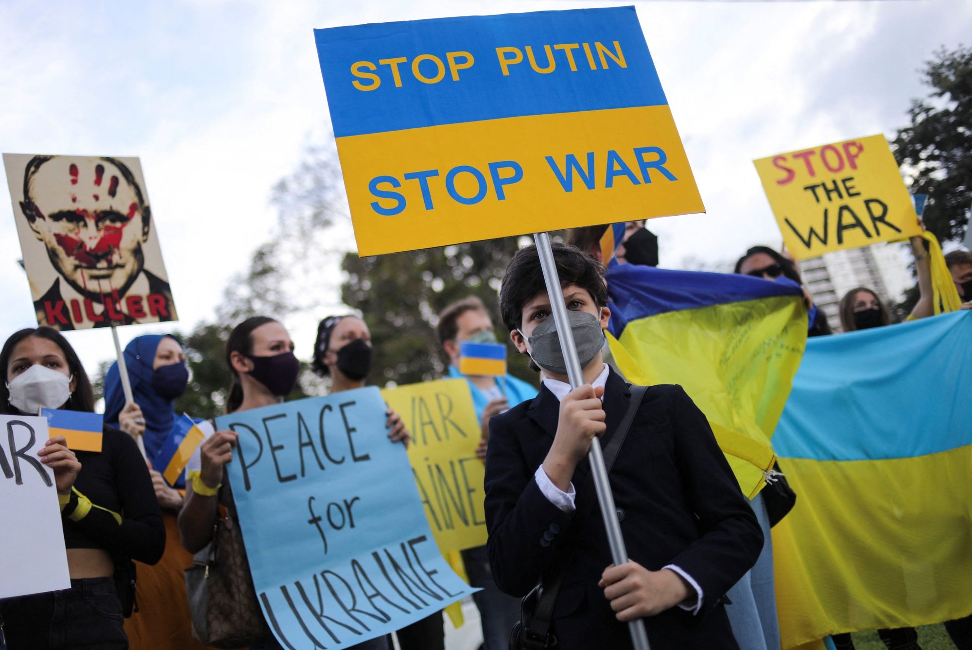A boy holds a placard that reads "Stop Putin" and "Stop war" during a protest outside the Russian Embassy in Kuala Lumpur, Malaysia, Feb. 28, 2022. (CNS photo/Hasnoor Hussain, Reuters)