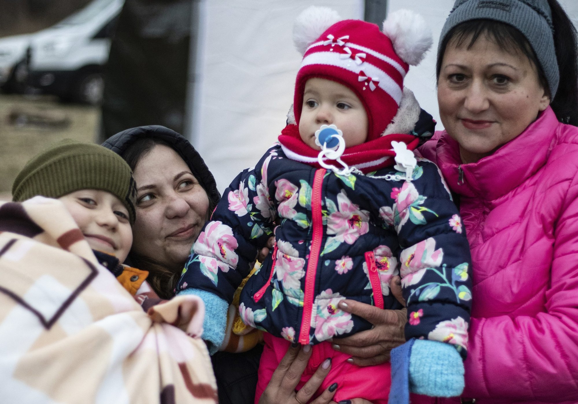 Yulia Tankano is pictured with her two children, Maksim and Victoria, and the children's grandmother, Valya, at a "refugee hub" at a former supermarket in Przemysl, Poland, near the Urkainian border, March 3, 2022. Since Russia's invasion began Feb. 24 more than 1.5 million refugees have fled Ukraine, the U.N. refugee agency said. (CNS photo/Romana Isabella)