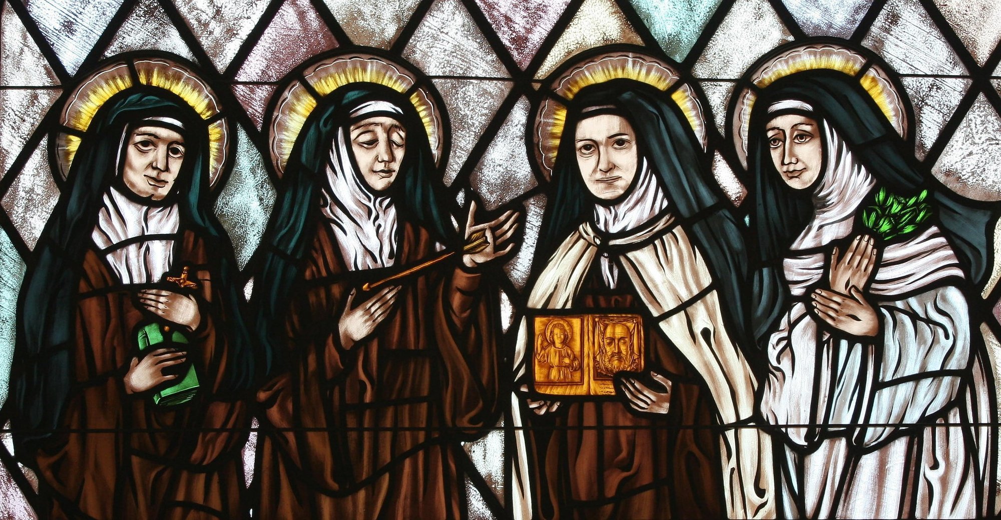 Sts. Edith Stein, Teresa of Ávila, Therese of Lisieux and Catherine of Siena are represented in stained glass at St. Thérèse of Lisieux Church in Montauk, N.Y. The Catholic Church needs women saints, Pope Francis said in a message to a conference in Rome on "Women Doctors of the Church and Co-Patronesses of Europe." (CNS photo/Gregory A. Shemitz, Long Island Catholic)