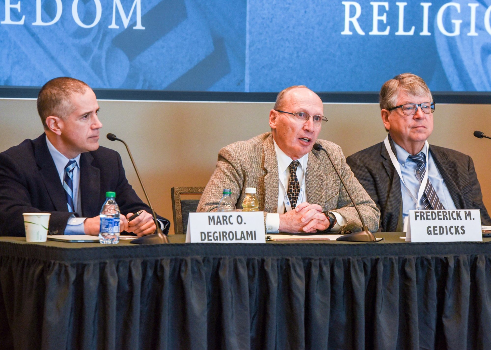 Frederick M. Gedicks, center, speaks March 25, 2022, during a conference titled "Beyond 'Defensive Crouch,' Religious Freedom" at George Mason University's Antonin Scalia Law School in Arlington, Va. Gedicks is a law professor at Brigham Young University's J. Reuben Clark Law School in Provo, Utah. Also pictured are Marc O. DeGirolami, left, a law professor at St. Johns University School of Law in Queens, N.Y., and Steven Smith, a law professor at the University of San Diego School of Law. (CNS photo/Zoey Maraist, Arlington Catholic Herald)