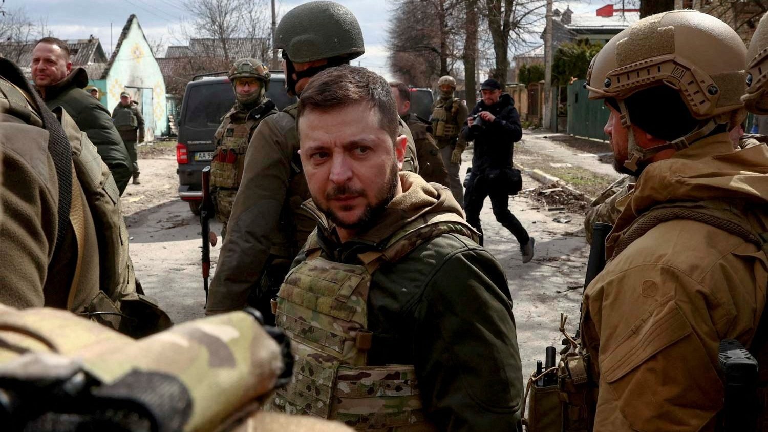 Ukrainian President Volodymyr Zelenskyy looks on as he is surrounded by Ukrainian servicemen as Russia's invasion of Ukraine continues in Bucha, outside Kyiv, Ukraine, April 4, 2022. (CNS photo/Marko Djurica, Reuters)