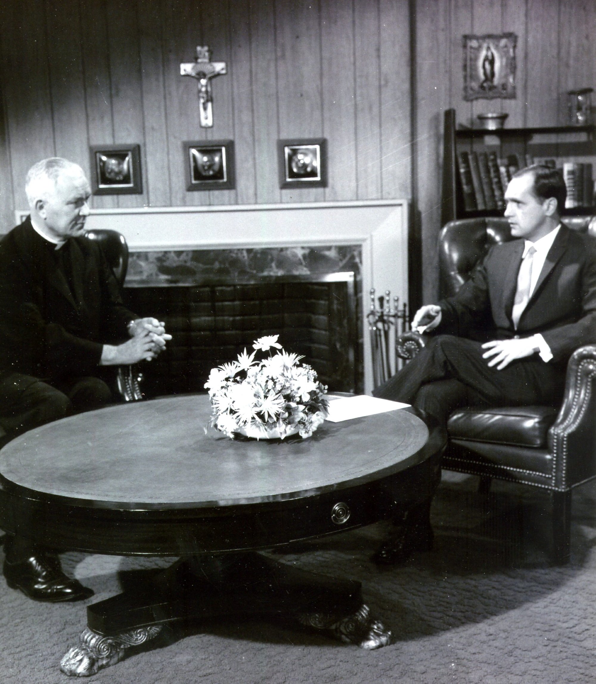 Holy Cross Father Patrick Peyton talks with actor Bob Newhart in this undated photo during a broadcast for Family Theater Productions, which the Irish-born priest founded in 1947. Father Peyton, a candidate for sainthood, worked with Newhart and many other Hollywood celebrities, including Lucille Ball, Bing Crosby and Loretta Young, on radio shows and later film and television programming. (CNS photo/courtesy Family Theater Productions)