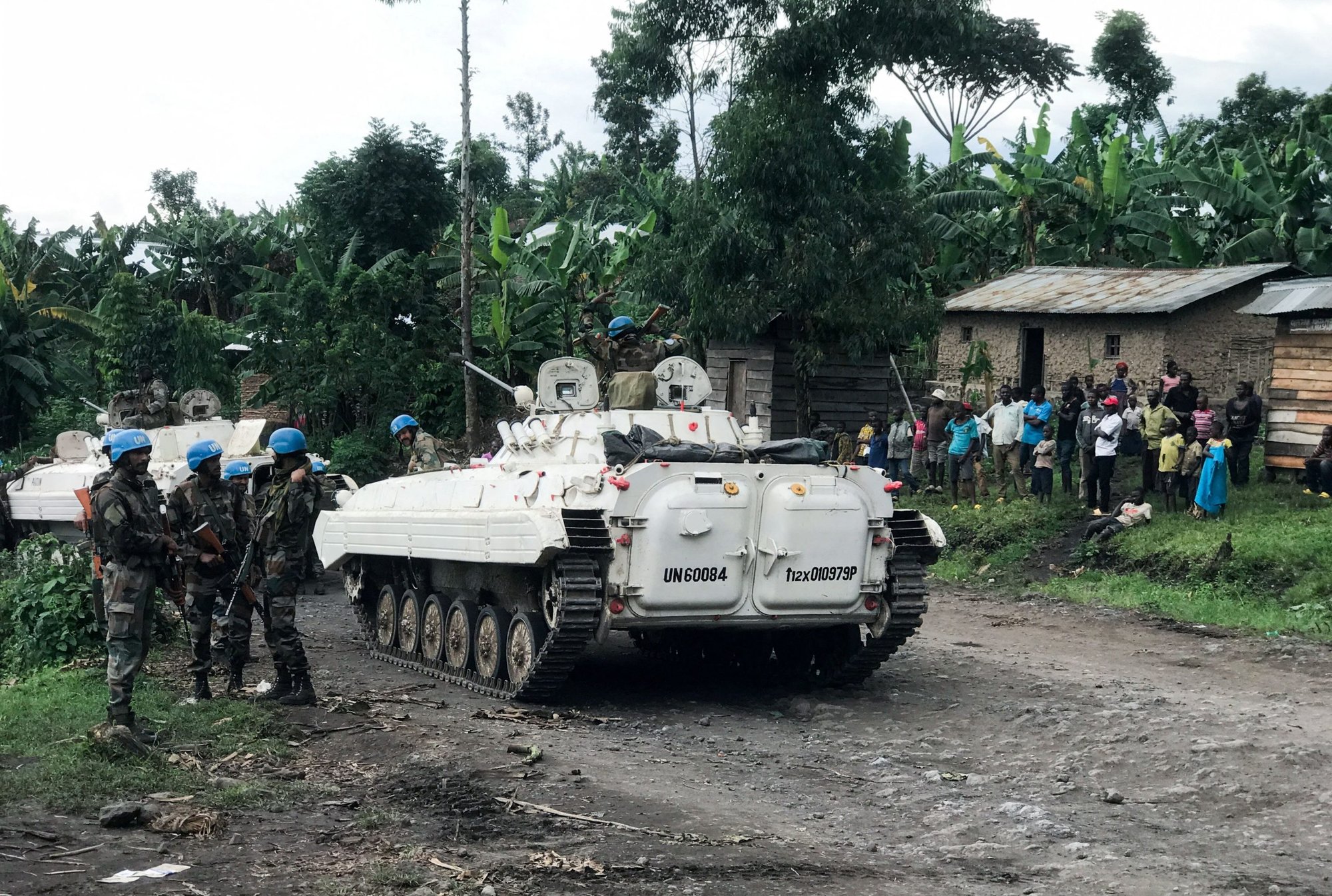 United Nations peacekeepers are pictured near Congolese standing outside their homes as they patrol areas affected by the recent attacks by M23 rebels fighters in North Kivu province March 29, 2022. Congolese Father Georges Kalenga, a member of the planning committee for Pope Francis' July 2-5, visit, said the pope will be visiting a country ravaged by conflict.(CNS photo/Djaffar Sabiti, Reuters)
