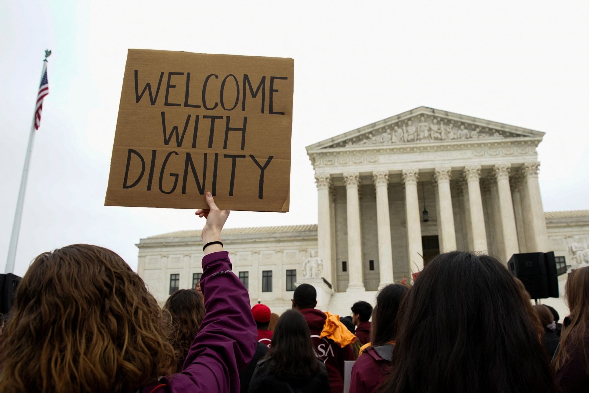 People in support of asylum seekers rally near the Supreme Court in Washington April 26, 2022, as the court hears oral arguments in President Joe Biden's bid to rescind a Trump-era immigration policy that forced migrants to stay in Mexico to await U.S. hearings on their asylum claims. (CNS photo/Elizabeth Frantz, Reuters)