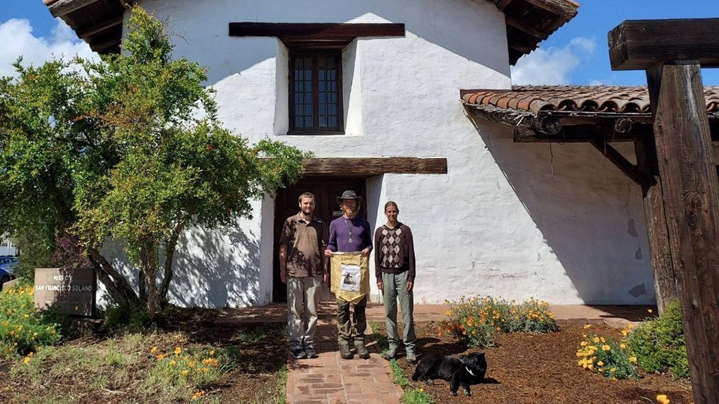 John Paul Hanson, Matthew Geier, Hope Waterman, and Laika, the dog, pose for a photo in front of the Sonoma Mission in Sonoma, Calif. They walked more than 800 miles in the footsteps of St. Junipero Serra on a Lenten pilgrimage to pray for California that spanned the 46 days from Ash Wednesday to Easter Vigil. (CNS photo/courtesy Greg Wood, via Archdiocese of San Francisco)