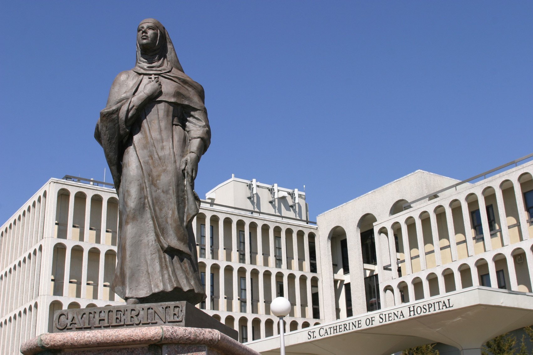 A statue of St. Catherine of Siena stands at the entrance to the medical center that bears her name in Smithtown, N.Y. (CNS photo/Gregory A. Shemitz, Long Island Catholic)