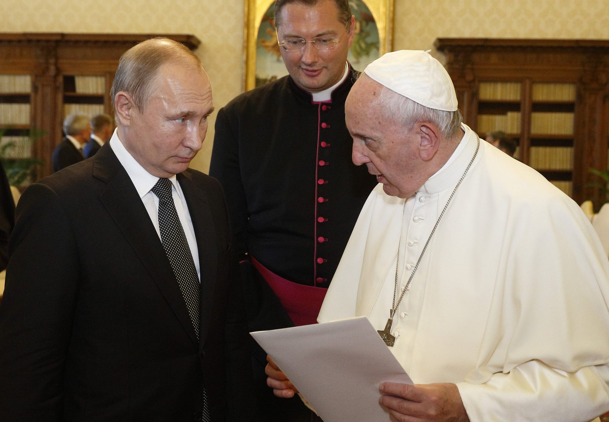 Father Visvaldas Kulbokas, center, serves as translator as Pope Francis and Russian President Vladimir Putin exchange gifts during a private audience at the Vatican in this July 4, 2019, file photo. In an interview with the Italian newspaper Corriere della Sera, published May 3, 2022, Pope Francis said he would like to go to Moscow to meet Vladimir Putin in an attempt to end the conflict in Ukraine. (CNS photo/Paul Haring)