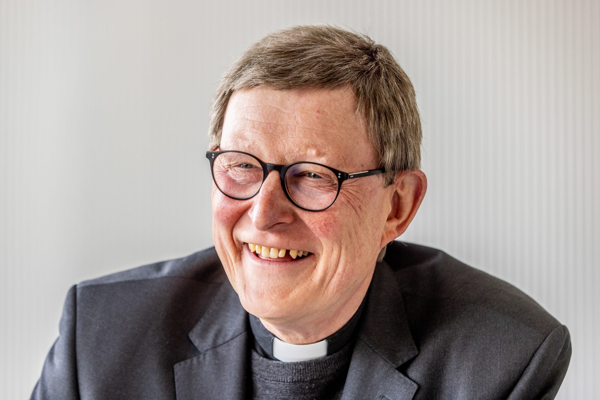 German Cardinal Rainer Maria Woelki of Cologne smiles during a news conference in Cologne May 2, 2022. Cardinal Woelki and Msgr. Markus Hofmann, vicar general of the archdiocese, did not violate canon law in their funding of investigations and hiring of communications consultants, said the Vatican. (CNS photo/Theo Barth, KNA)