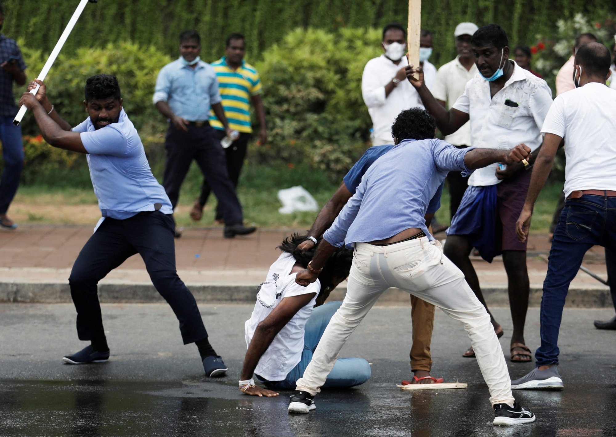 Supporters of the Sri Lankan ruling party attack an anti-government demonstrator during clashes between the two groups in Colombo May 9, 2022. (CNS photo/Dinuka Liyanawatte, Reuters)