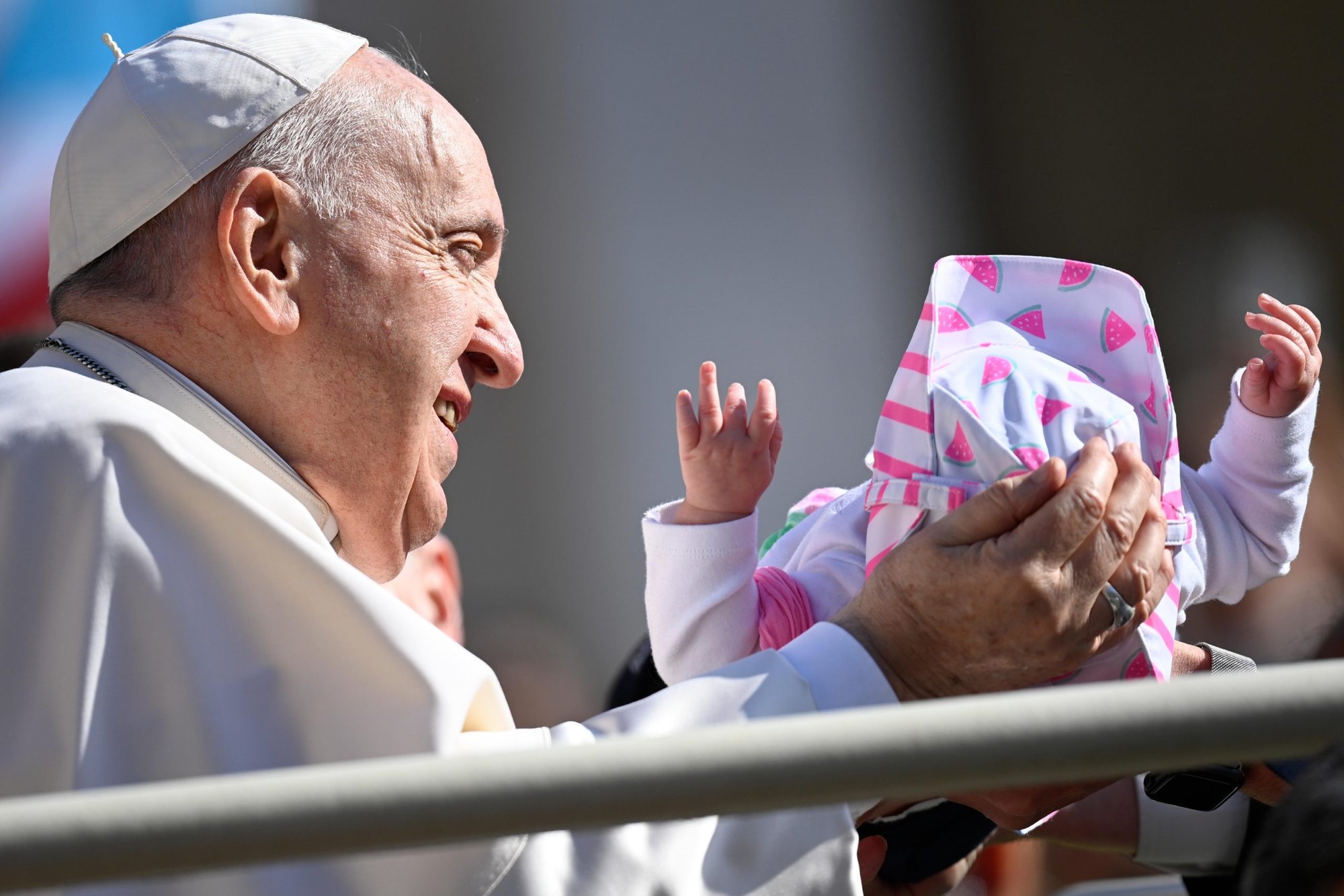 Pope Francis cradles a baby as he arrives for his general audience in St. Peter's Square at the Vatican May 11, 2022. (CNS photo/Guglielmo Mangiapane, Reuters)