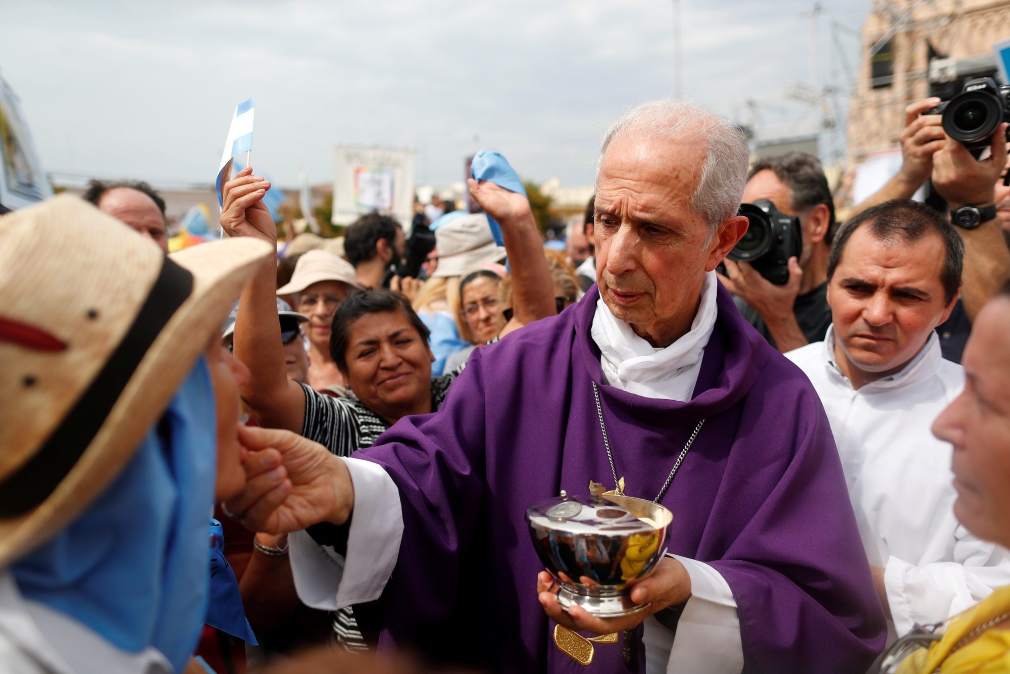 Cardinal Mario Poli of Buenos Aires, Argentina, distributes Communion during a Mass outside the Basilica of Our Lady of Lujan in Buenos Aires March 8, 2020. An audit ordered by the Vatican into the Archdiocese of Buenos Aires has revealed irregularities in the sales of church assets, but said no crimes were committed. (CNS photo/Agustin Marcarian, Reuters)