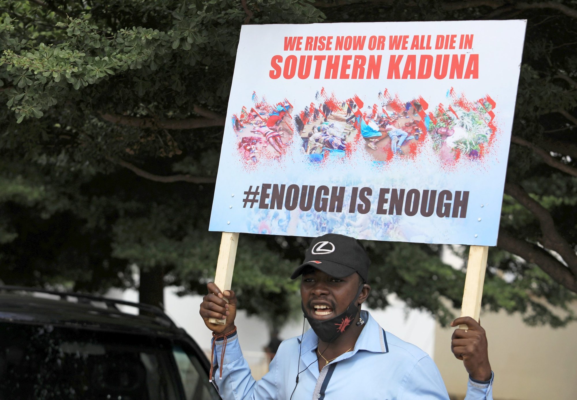 A man holds up a sign against killings in southern Kaduna state and insecurities in Nigeria during a protest in Abuja Aug. 15, 2020. The Archdiocese of Kaduna announced May 12, 2022, that Father Joseph Aketeh Bako, a priest kidnapped in March, was killed by his captors. (CNS photo/Afolabi Sotunde, Reuters)
