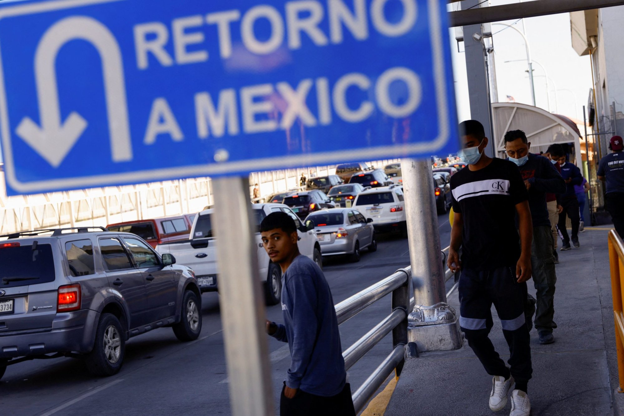 Migrants expelled from the U.S. and sent back to Mexico under Title 42 walk toward Mexico at the Paso del Norte International border bridge in Ciudad Juarez, Mexico, May 21, 2022. The U.S. health policy restriction, enforced by the Trump administration, has kept some migrants out of the U.S. because of COVID-19 concerns. (CNS photo/Jose Luis Gonzalez, Reuters)