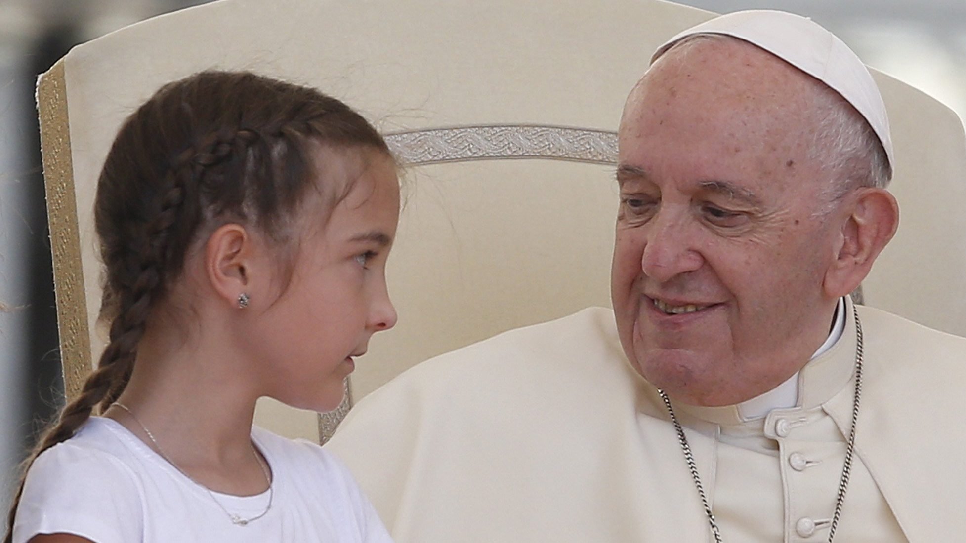 Pope Francis greets a girl during his general audience in St. Peter's Square at the Vatican May 25, 2022. (CNS photo/Paul Haring)