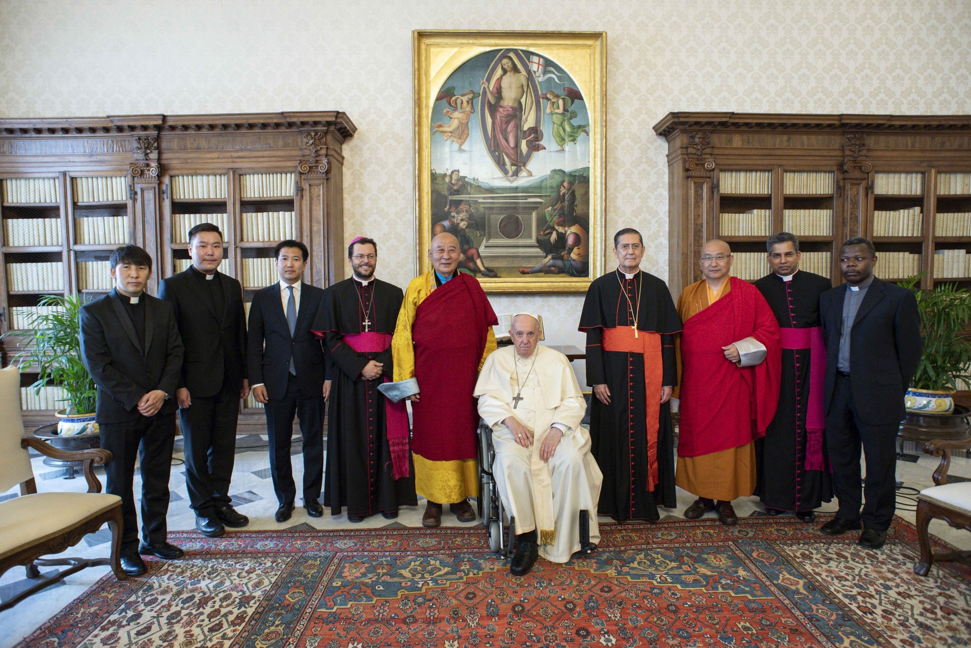 Pope Francis poses for group photo during an audience with Buddhist leaders from Mongolia at the Vatican May 28, 2022. Also present were Bishop Giorgio Marengo, apostolic prefect of Ulaanbaatar, Mongolia, who was named a cardinal by the pope May 29; and Cardinal Miguel Angel Ayuso Guixot, president of the Pontifical Council for Interreligious Dialogue. (CNS photo/Vatican Media)