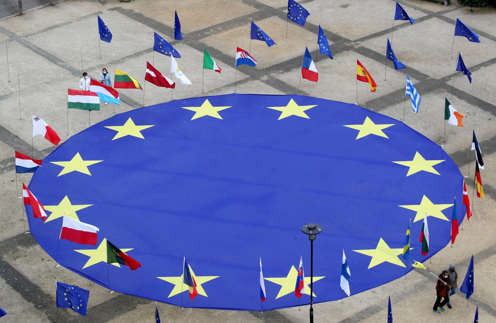 A large European Union flag lies at the center of Schuman Square outside of the EU headquarters in Brussels May 8, 2021. (CNS photo/Yves Herman, Reuters)
