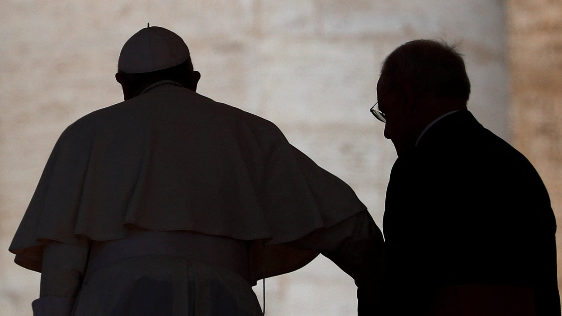 Pope Francis is assisted by Msgr. Leonardo Sapienza, an official of the Prefecture of the Papal Household, following the pontiff's general audience in St. Peter's Square at the Vatican April 27, 2022. The pope is suffering from a torn ligament and bursitis in his knee. (CNS photo/Guglielmo Mangiapane, Reuters)