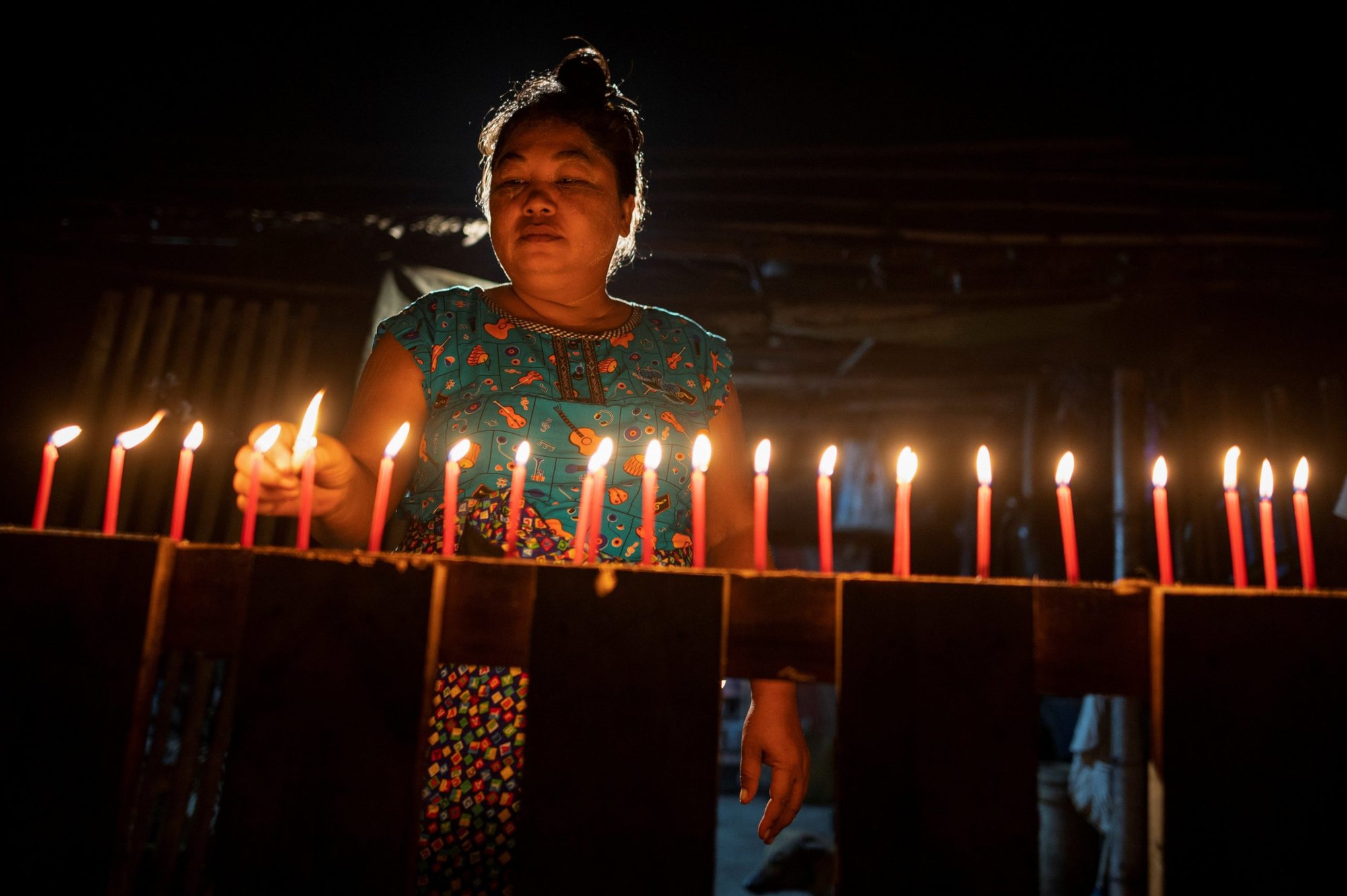 A woman in Yangon, Myanmar, lights candles during the Festival of Lights Oct. 31, 2020. Myanmar, in Southeast Asia, is among countries singled out in the U.S. State Department's 2021 Report on International Religious Freedom for abusing citizens' religious rights. The report, which calls the country by its former name of Burma, was released in Washington June 2, 2022. (CNS photo/Shwe Paw Mya Tin, Reuters)