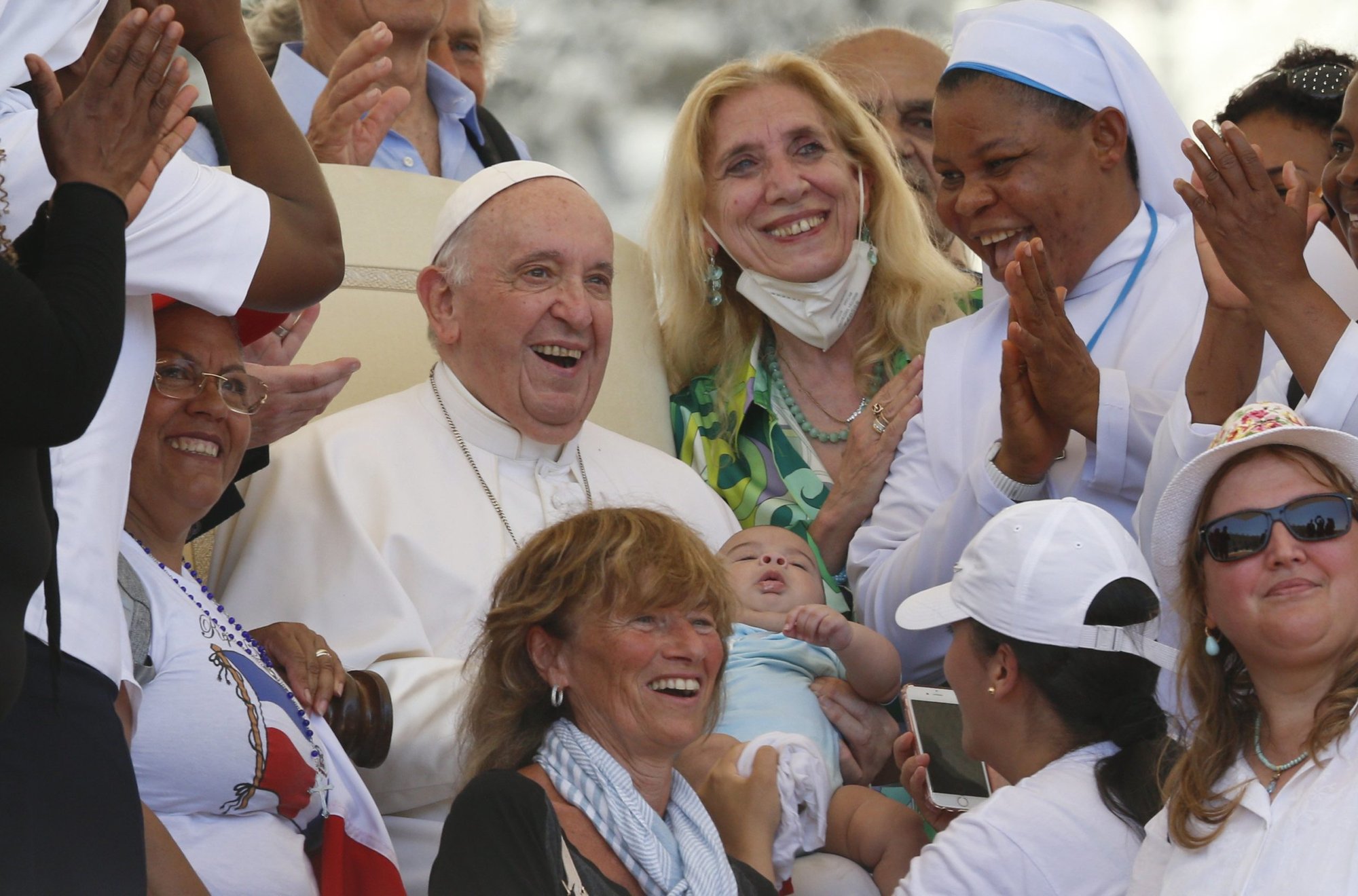 Pope Francis holds a baby as he meets a group during his general audience in St. Peter's Square at the Vatican June 8, 2022. (CNS photo/Paul Haring)