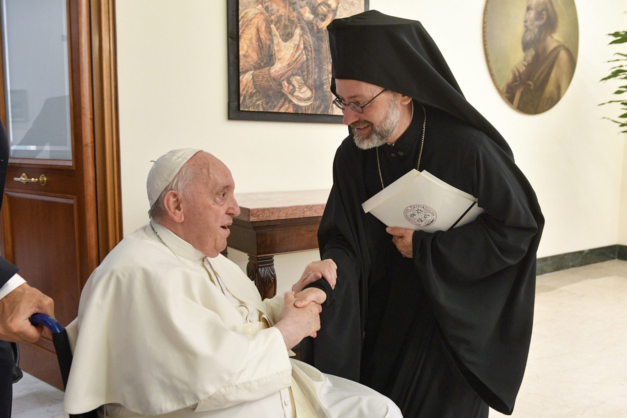 Pope Francis greets Orthodox Archbishop Job of Telmessos while meeting a delegation representing the Ecumenical Patriarchate of Constantinople at the Domus Sanctae Marthae at the Vatican June 30, 2022. The delegation was in Rome to celebrate the June 29 feast of Sts. Peter and Paul at the Vatican. (CNS photo/Vatican Media)