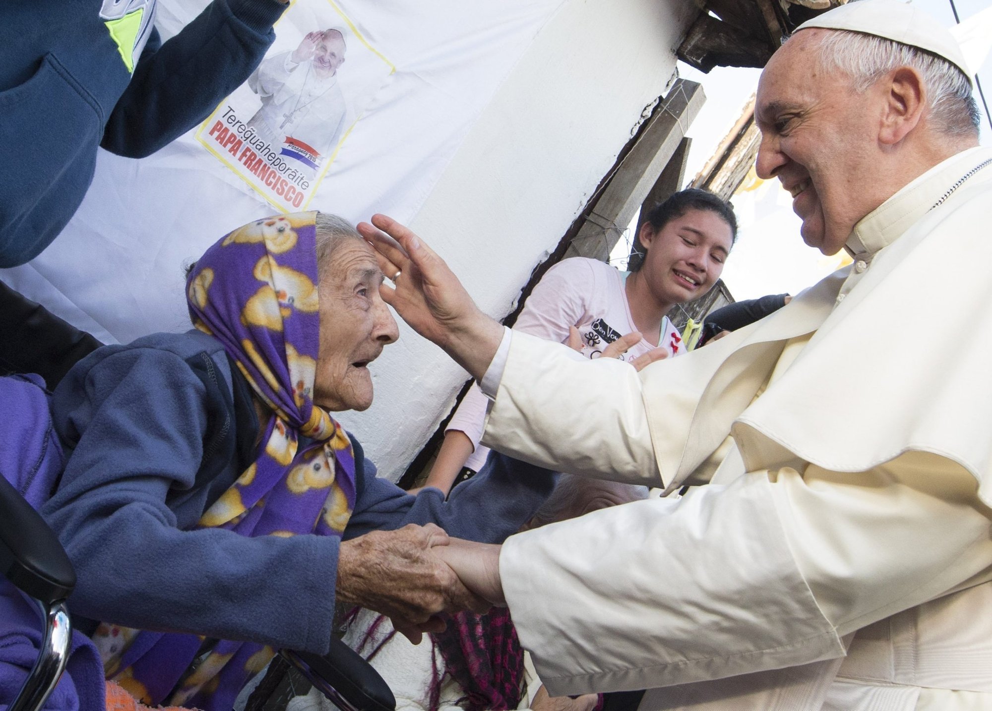 Pope Francis greets an elderly woman as he meets with people in Asuncion, Paraguay, in this July 12, 2015, file photo. The pope's prayer intention for the month of July, dedicated to the elderly, was released June 30, 2022, by the Pope's Worldwide Prayer Network. (CNS photo/Paul Haring)