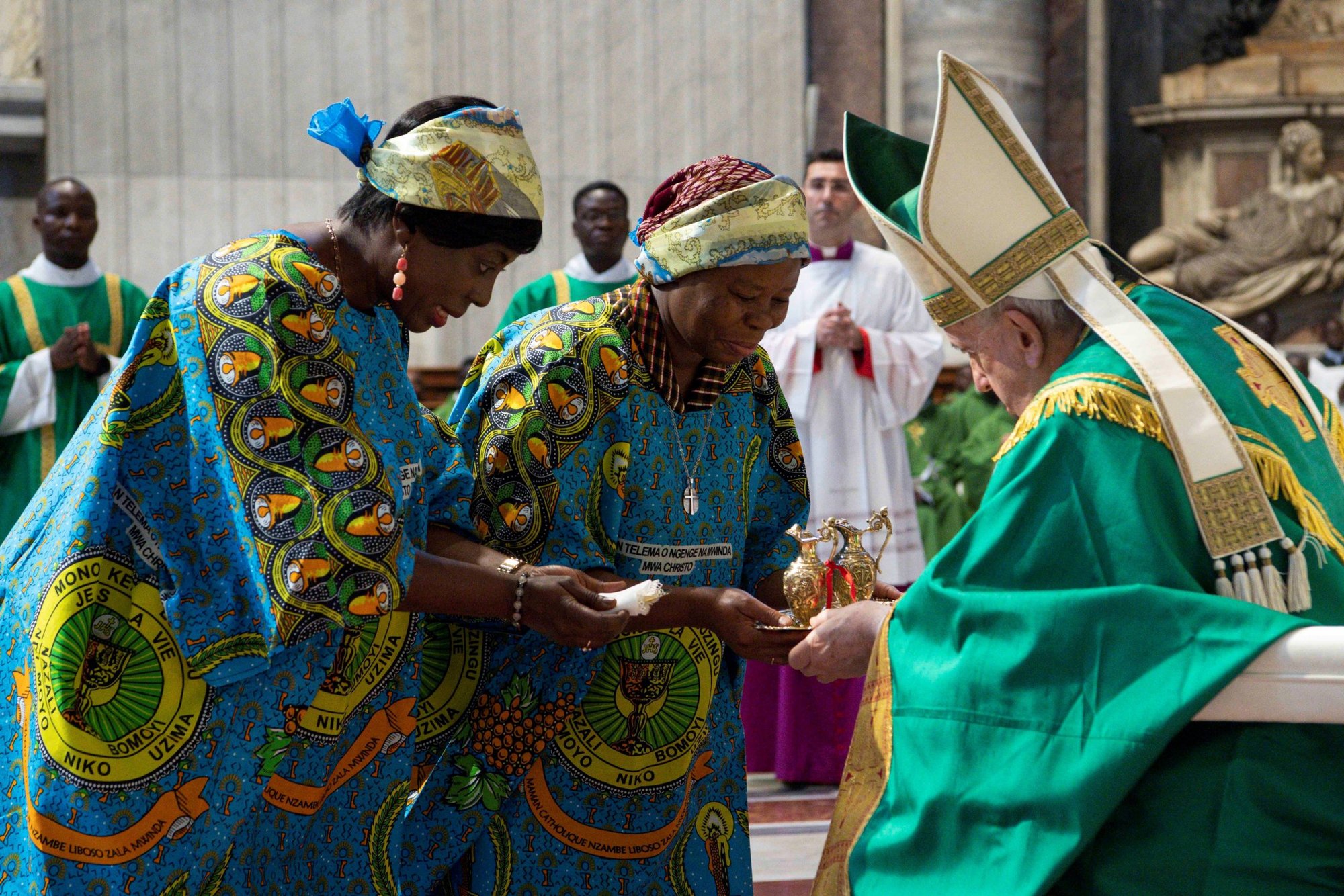 Two members of the Congolese community in Rome present the offertory gifts to Pope Francis during Mass in St. Peter's Basilica at the Vatican July 3, 2022. Pope Francis was to have been in Kinshasa, Congo, that day, but was forced to postpone the trip because of problems with his knee. (CNS photo/Vatican Media)