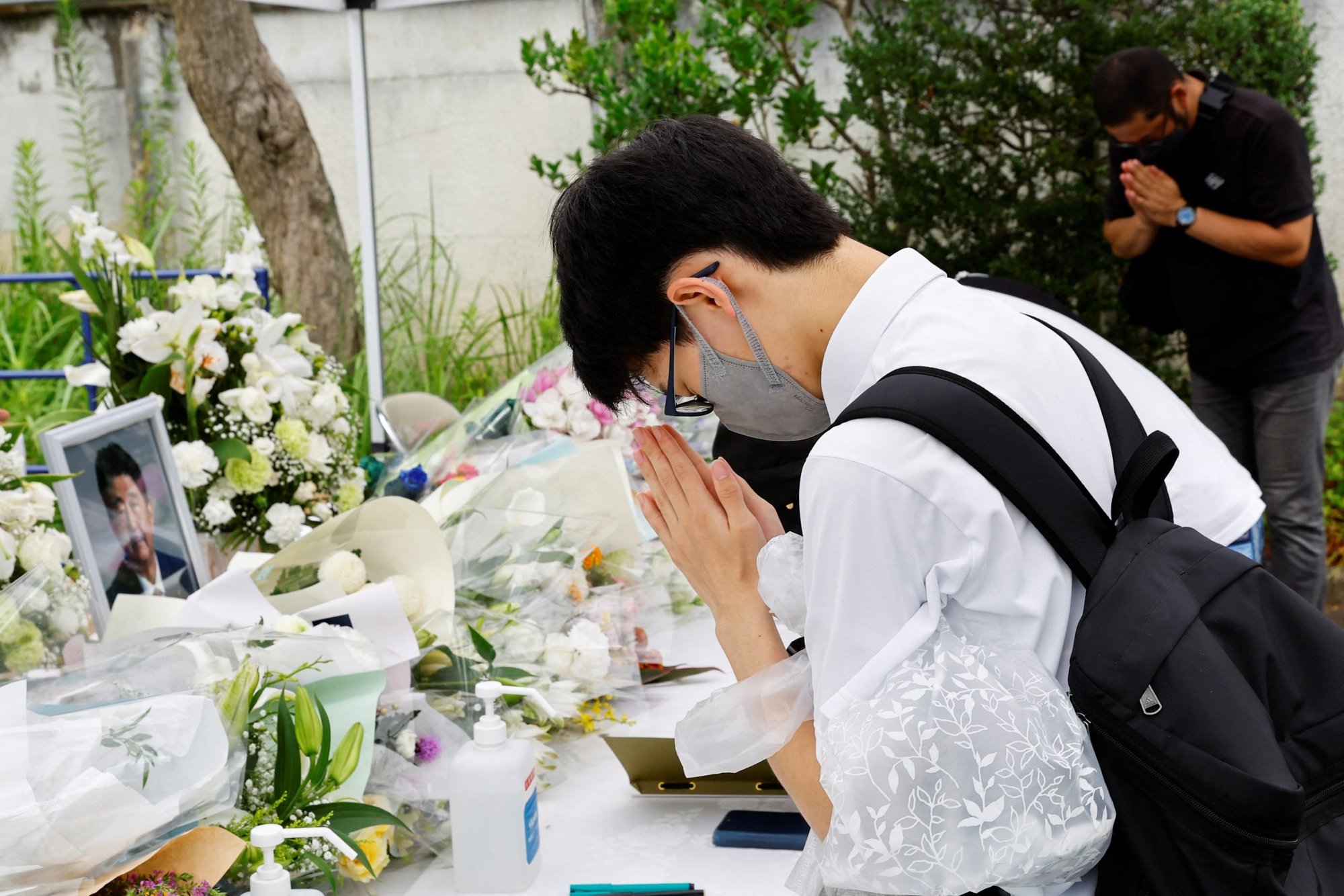 Mourners pray for the late former Japanese Prime Minister Shinzo Abe at the headquarters of the Japanese Liberal Democratic Party in Tokyo July 12, 2022. Archbishop Isao Kikuchi of Tokyo strongly condemned the July 8 assassination of Abe, and deplored violence as a means of solving political differences. (CNS photo/Kim Kyung-Hoon, Reuters)