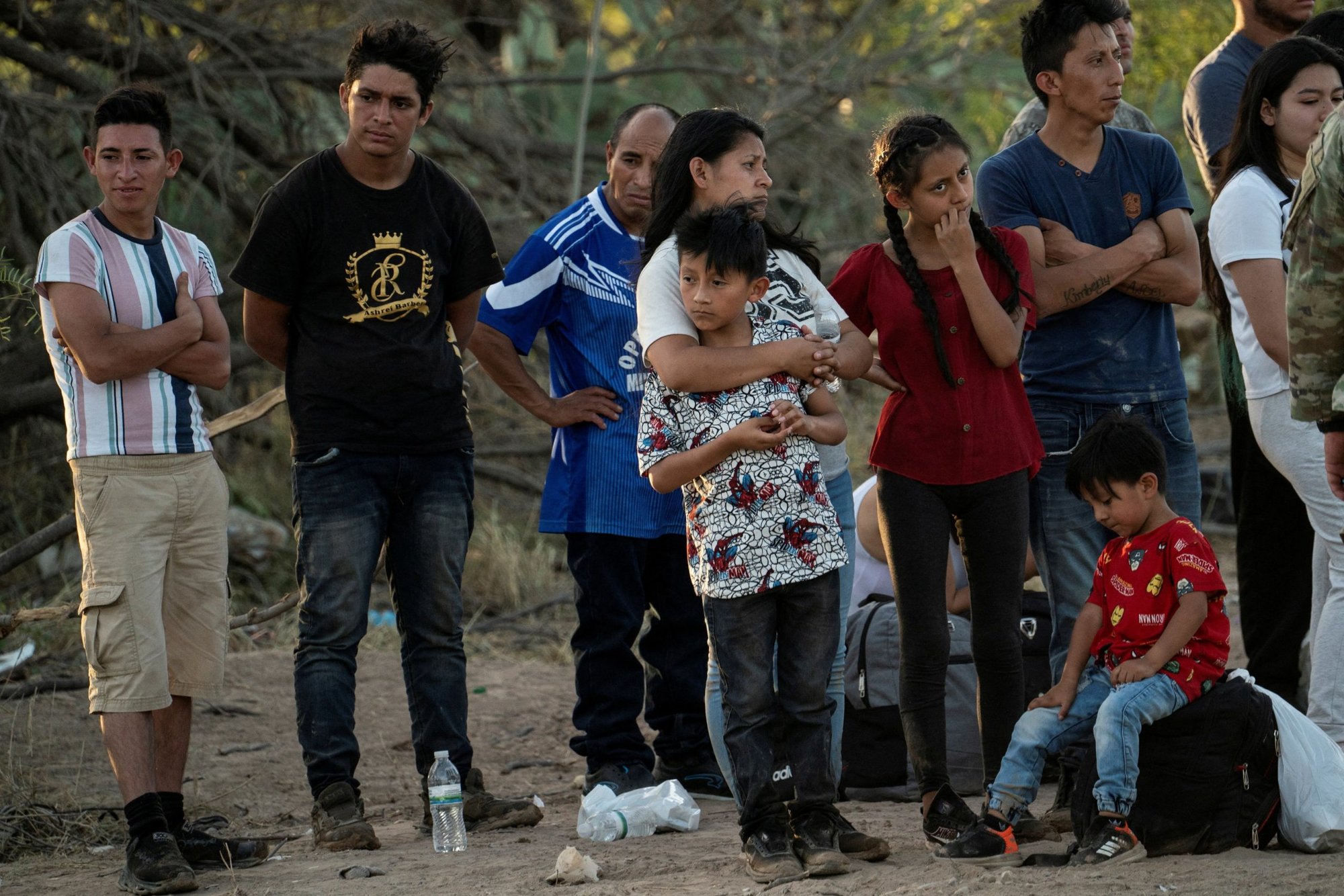 Asylum-seeking migrants wait to be transported by U.S. Customs and Border Protection agents, after crossing the Rio Grande into the U.S. from Mexico, in Eagle Pass, Texas, July 26, 2022. (CNS photo/Go Nakamura, Reuters)