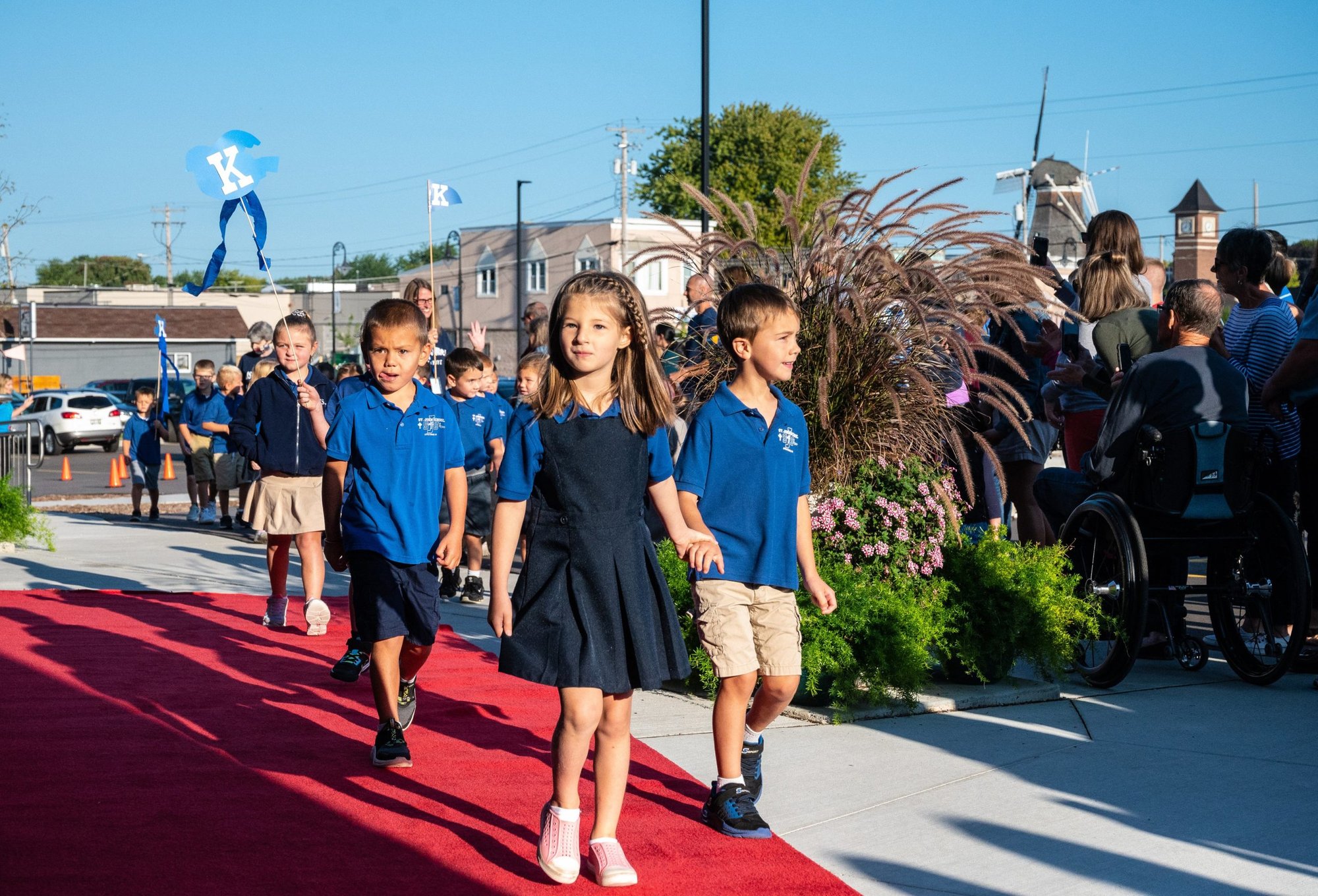 Students at St. John Nepomucene School in Little Chute, Wis., walk on a red carpet as they go to Mass Sept. 10, 2021, for their first all-school Mass of the 2021-2022 school year. (CNS photo/Sam Lucero, The Compass)