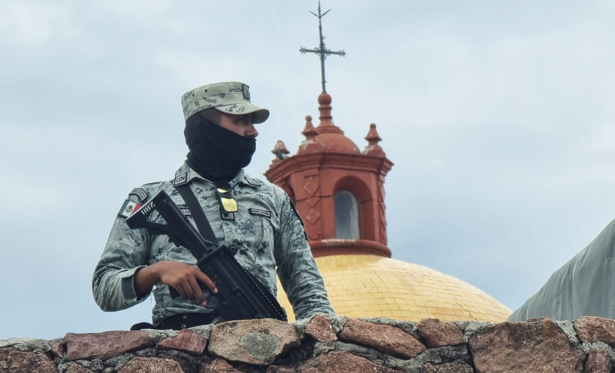 A member of the Mexican army stands guard outside a church in the parish community of Cerocahui June 22, 2022. Jesuit Fathers Javier Campos Morales and Joaquín César Mora Salazar were murdered at the parish June 20 as they offered refuge to a tour guide seeking protection. (CNS photo/Reuters)
