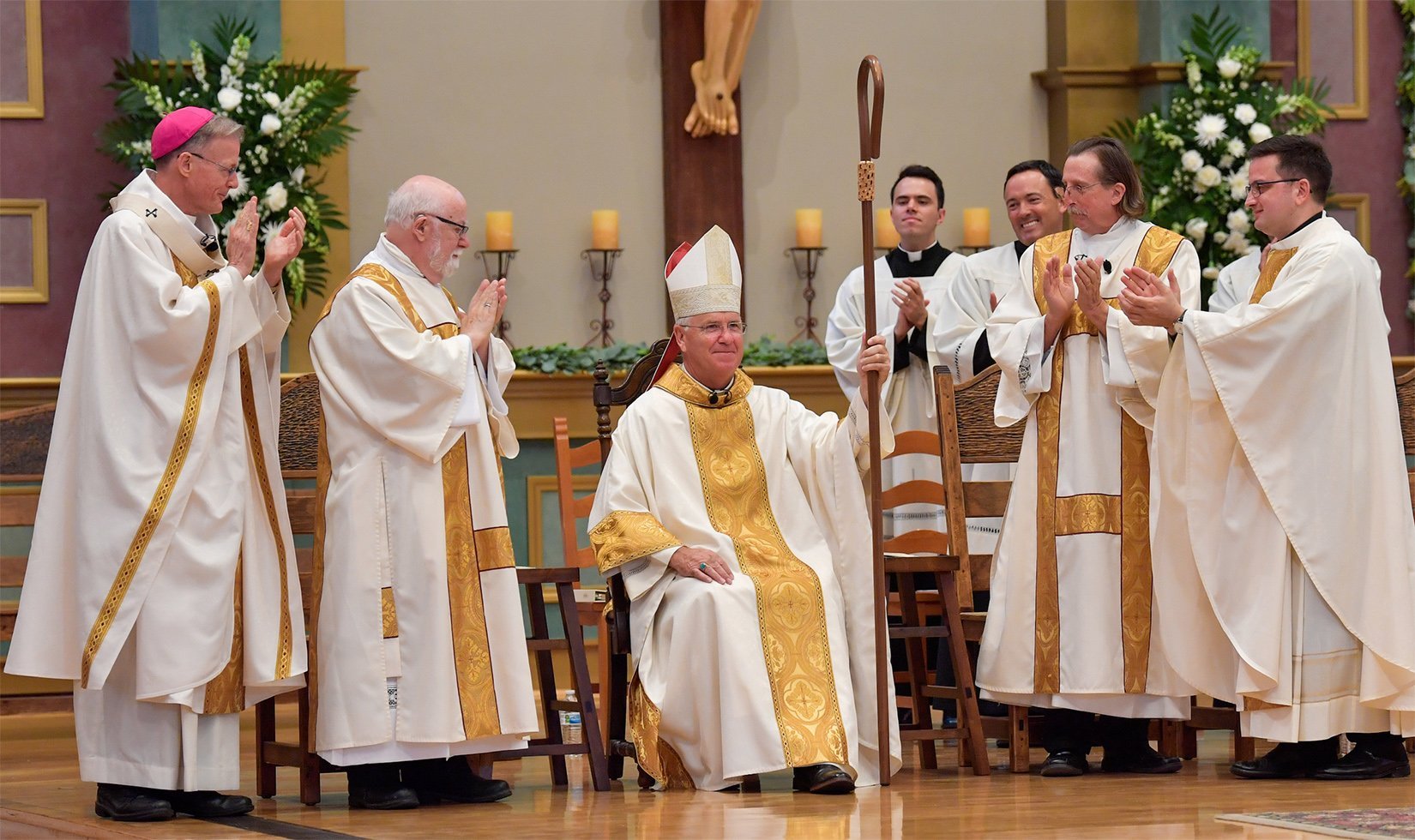 Bishop John P. Dolan, seated, is seen at St. Thomas Aquinas Church in Avondale, Ariz., Aug. 2, 2022, after being installed as the fifth bishop of the Diocese of Phoenix. (CNS photo/Brett Meister, The Catholic Sun)