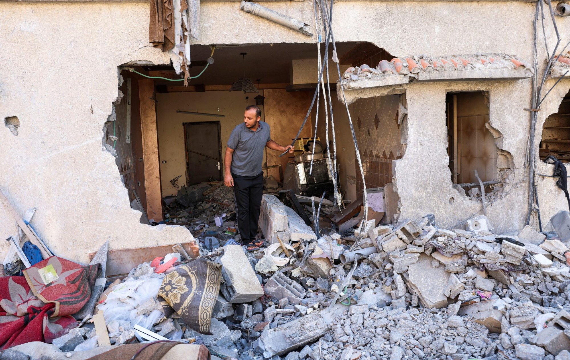 A Palestinian man inspects his house that was damaged during Israeli airstrikes on Gaza City Aug. 8, 2022. (CNS photo/Suhaib Salem, Reuters)