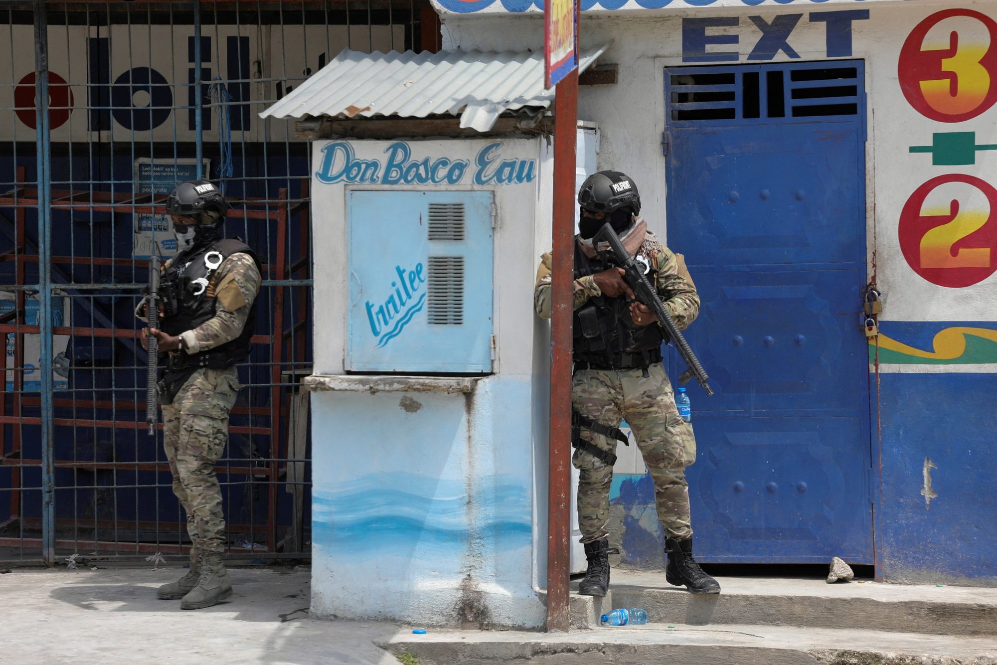 Members of the Haitian National Police patrol a street as ongoing gun battles between rival gangs forced residents to flee their homes in Port-Au-Prince April 28, 2022. Religious orders working in Haiti have called on the international community to directly intervene to address the reign of terror of armed gangs they described as "diabolical, frightening and unacceptable." (CNS photo/Ralph Tedy Erol, Reuters)
