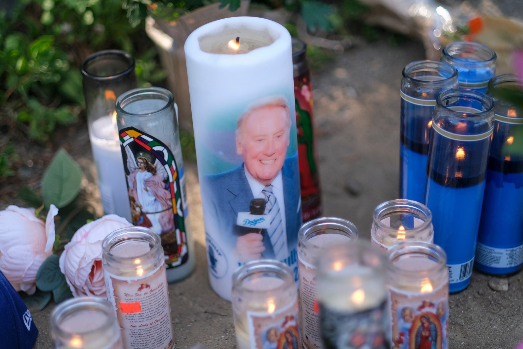 Flowers and candles are displayed at a memorial honoring Vin Scully at Dodger Stadium in Los Angeles Aug. 3, 2022. (Shutterstock)