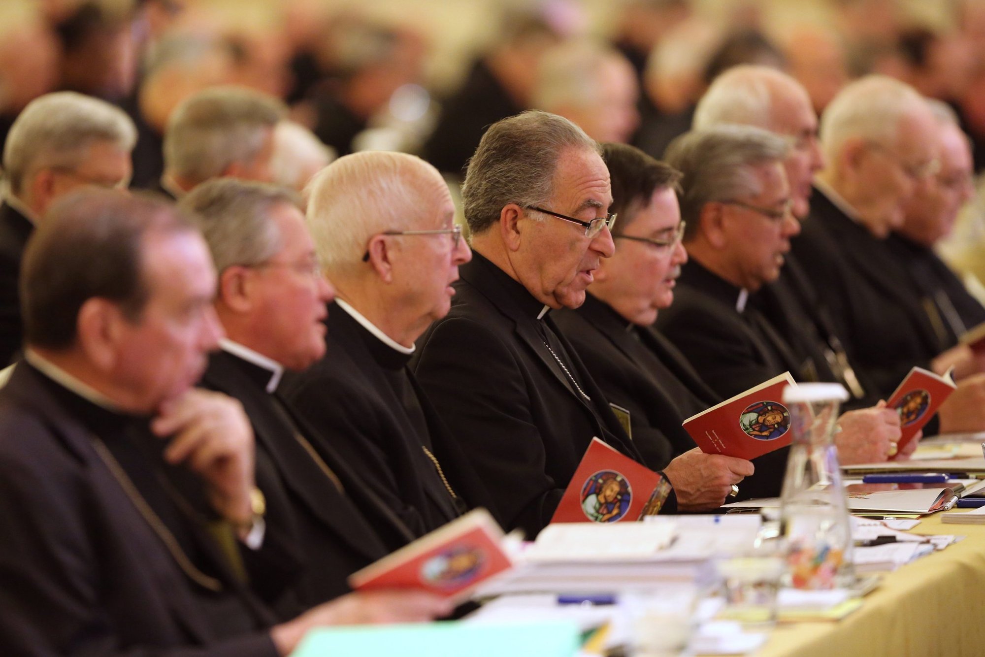 Bishops pray during the 2017 fall general assembly of the U.S. Conference of Catholic Bishops in Baltimore. Pope Francis' reform of the Roman Curia emphasizes work in the Vatican as a service not only to the pope, but also to dioceses and eparchies and bishops and bishops' conferences around the world. (CNS photo/Bob Roller)