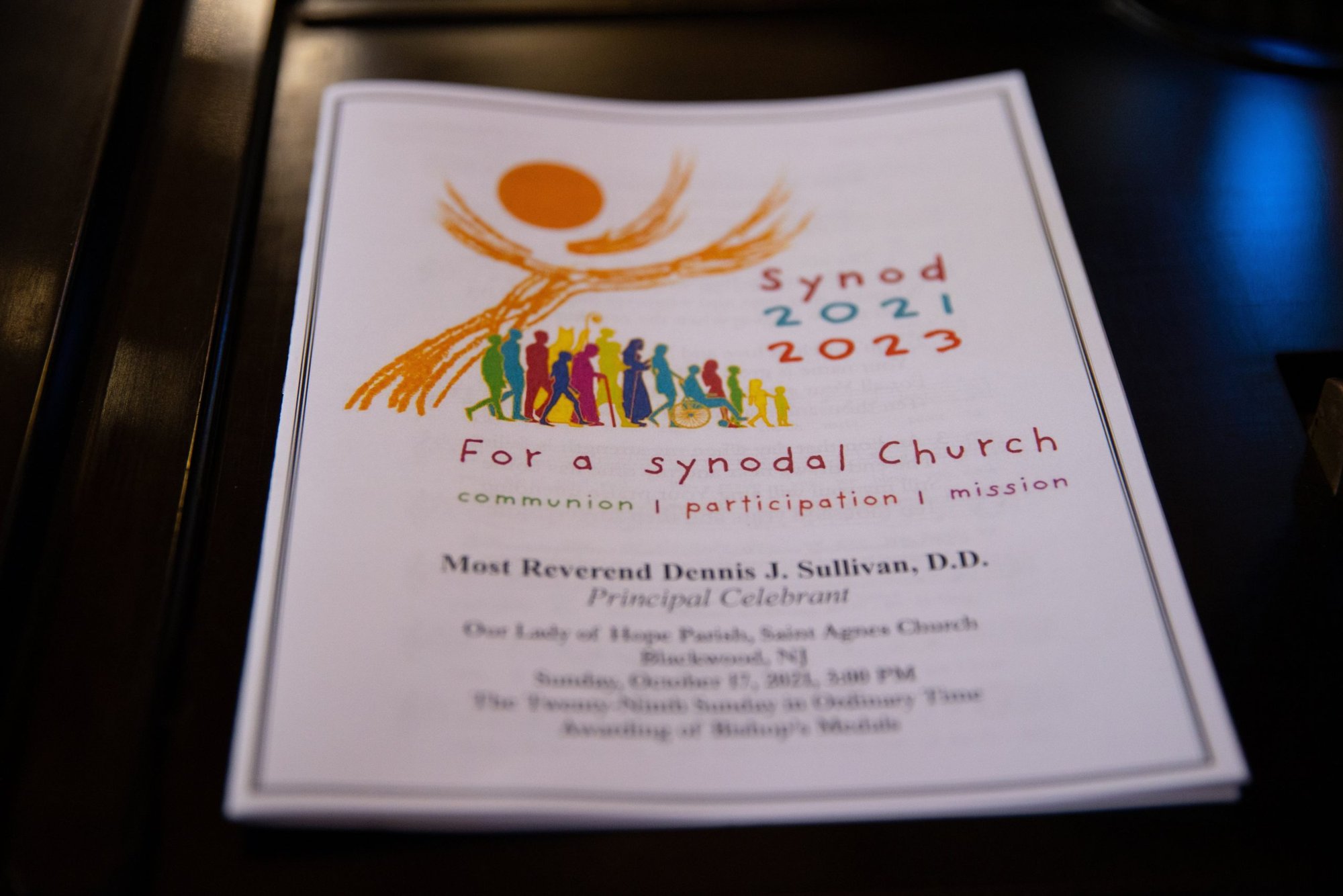 A program for a Mass opening the synod process in the Diocese of Camden, N.J., is seen at St. Agnes Church of Our Lady of Hope Parish in Blackwood, N.J., Oct. 17, 2021. Over several months reflections were collected from the faithful in parishes across the diocese and put before diocesan teams and deaneries as part of the churchwide preparation process for the 2023 word Synod of Bishops on synodality. (CNS photo/Dave Hernandez, Catholic Star Herald)