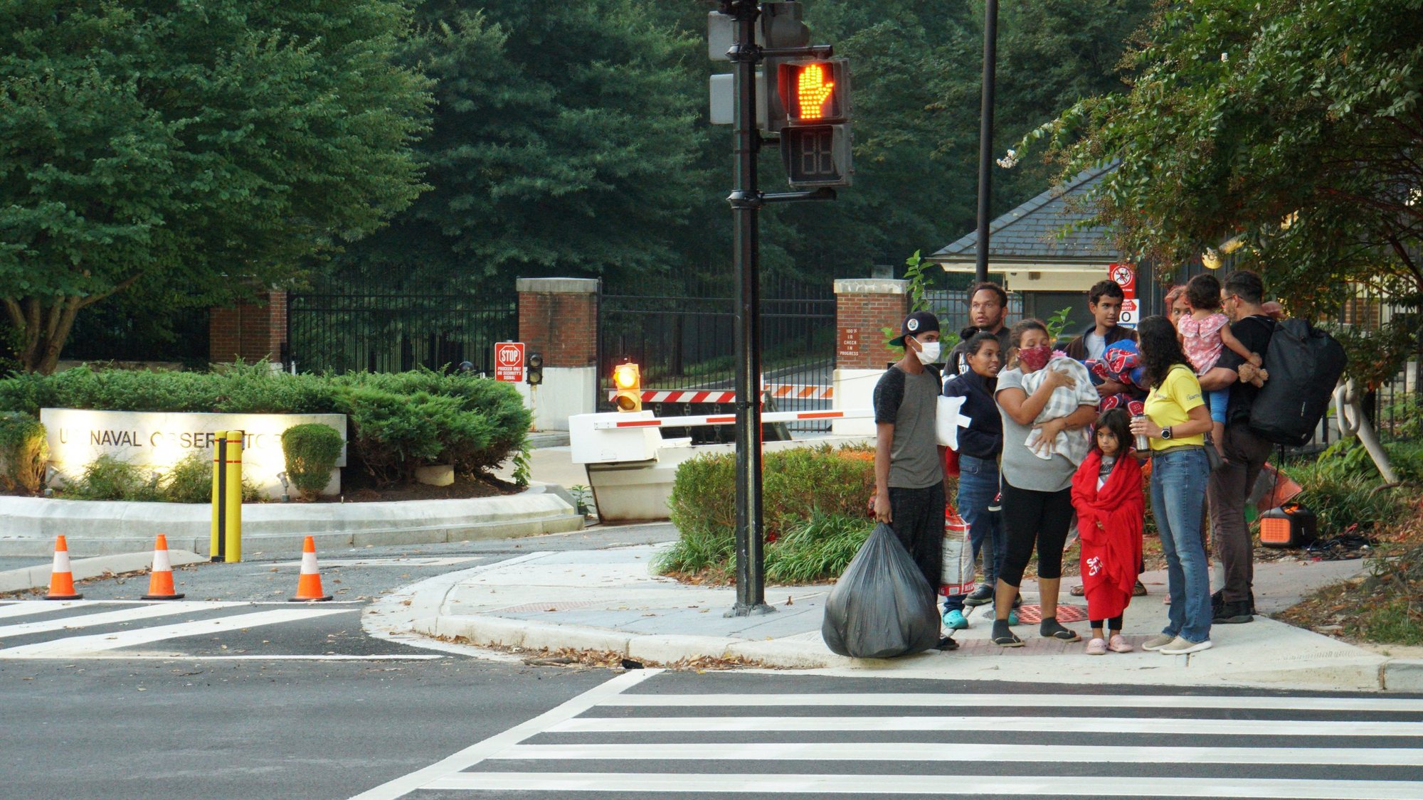 A group of mainly Venezuelan migrants wait for transport in Washington, Sept. 17, 2022, after arriving by bus from detention in Texas and being dropped off outside the Naval Observatory, the official residence of Vice President Kamala Harris. (CNS photo/Marat Sadana, Reuters)