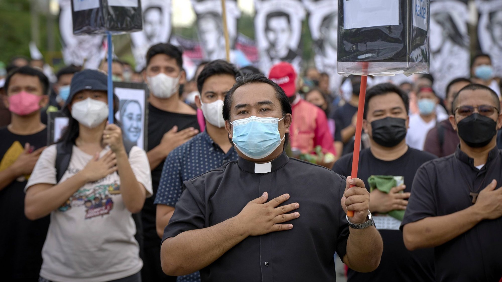 A priest and other church activists sing the national anthem during a Sept. 21, 2022, gathering in Manila marking the 50th anniversary of martial law in the the country. The gathering remembered church activists killed during martial law, which was imposed in 1972 by President Ferdinand Marcos Sr. and lasted until a pro-democracy uprising drove Marcos from office in 1986. (CNS photo/Paul Jeffrey)