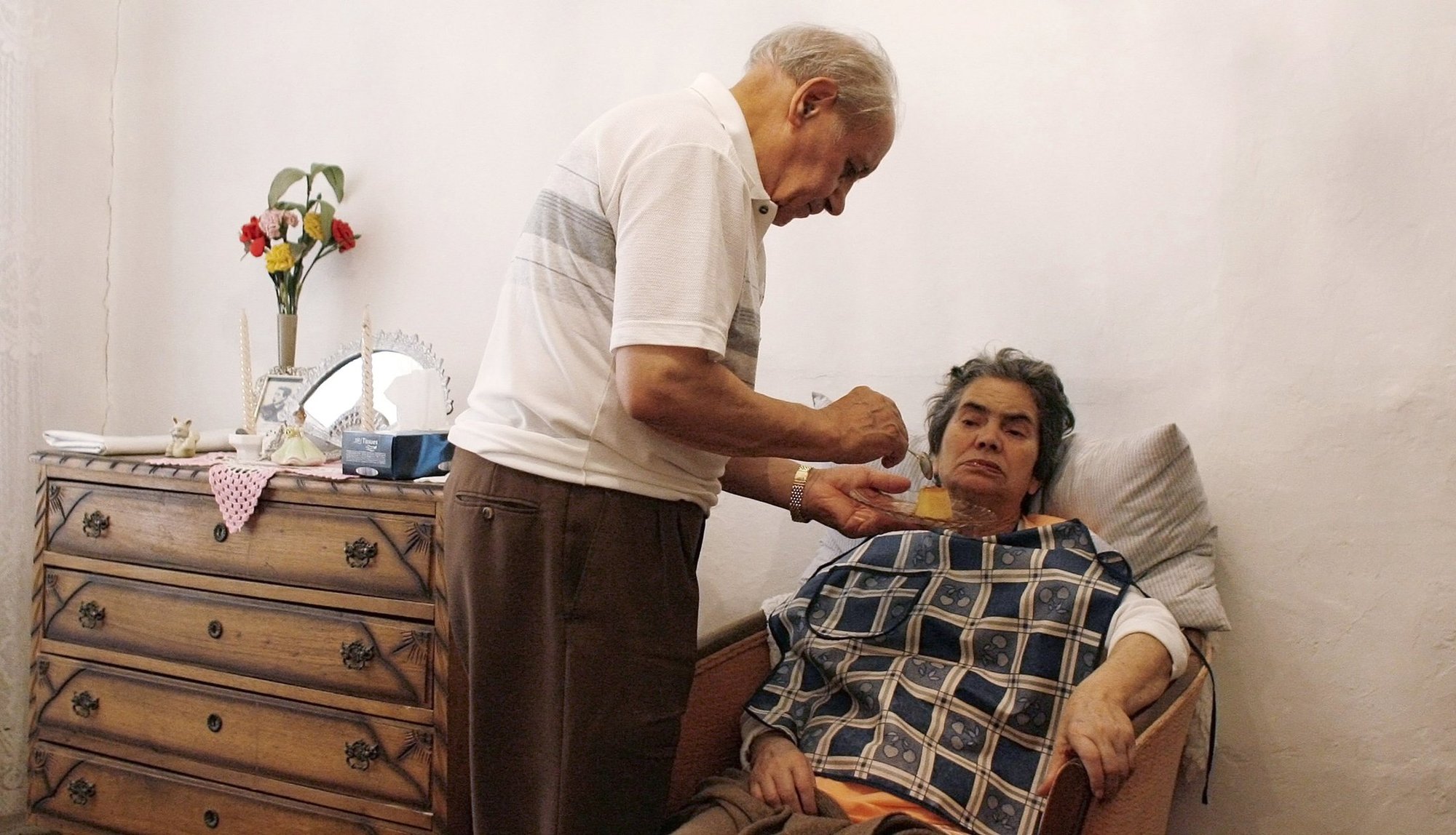 A husband feeds his wife, an Alzheimer's patient, in their house in Lisbon, Portugal, in this 2009, file photo. At his general audience Sept. 21, 2022, Pope Francis marked World Alzheimer's Day. (CNS photo/Nacho Doce, Reuters)