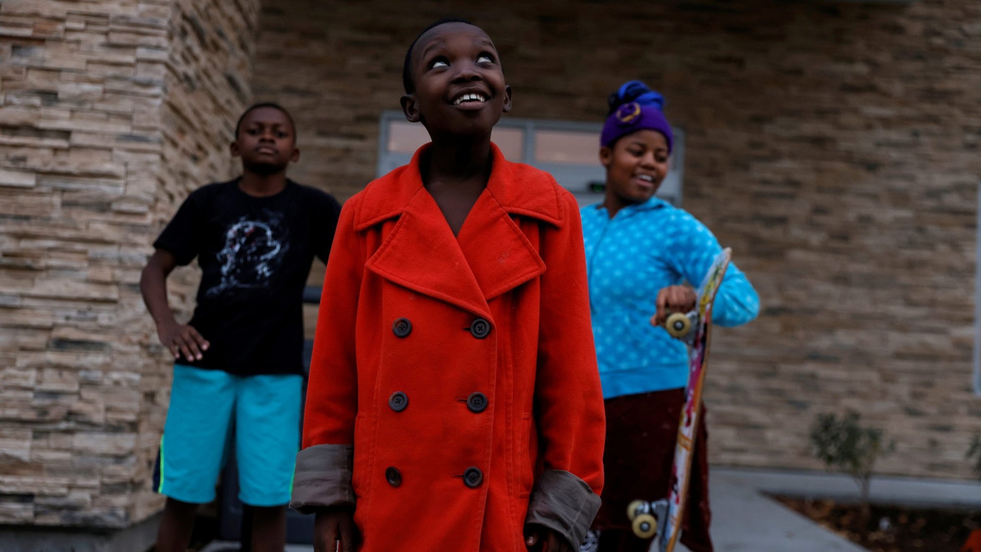 Children from Congo who have received refugee status in the U.S. stand outside a temporary hotel residence in Boise, Idaho, Oct. 29, 2021. President Joe Biden announced Sept. 27, 2022, the nation's cap on refugee admissions is 125,000 for the 2023 fiscal year. (CNS photo/Shannon Stapleton, Reuters)