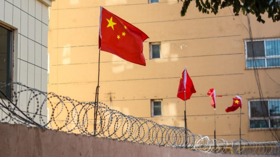 Chinese flags on barbed wired wall in Kashgar (Kashi), Xinjiang, China. (Jonathan Densford/Shutterstock via CNA)