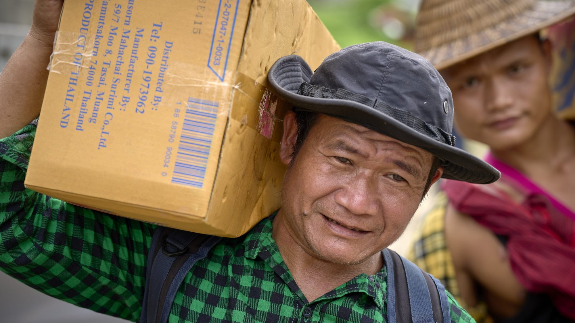 Pah Kler, a Burmese Catholic catechist who supervises the movement of food and other humanitarian supplies to internally displaced families hiding in the forests of Myanmar, loads food on a boat in Mae Sam Laep, a Thai village on the Salween River, which marks the border between Thailand and Myanmar, Sept. 29, 2022. Boats are loaded here with food and other humanitarian supplies, the first stage of transporting the material to communities of displaced people within Myanmar. (CNS photo/Paul Jeffrey)