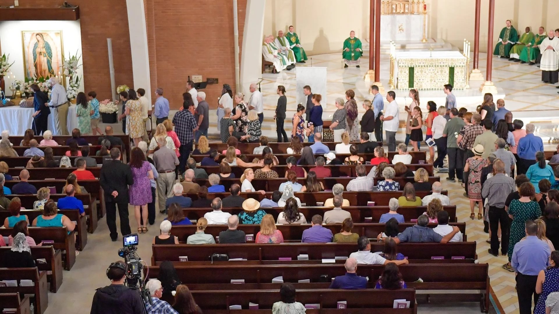 People line up to place carnations in memory of suicide victims during the Diocese of Phoenix’s Mass of Remembrance at Ss. Simon & Jude Cathedral in Phoenix Sept. 4, 2022. (Brett Meister/The Catholic Sun via CNS)