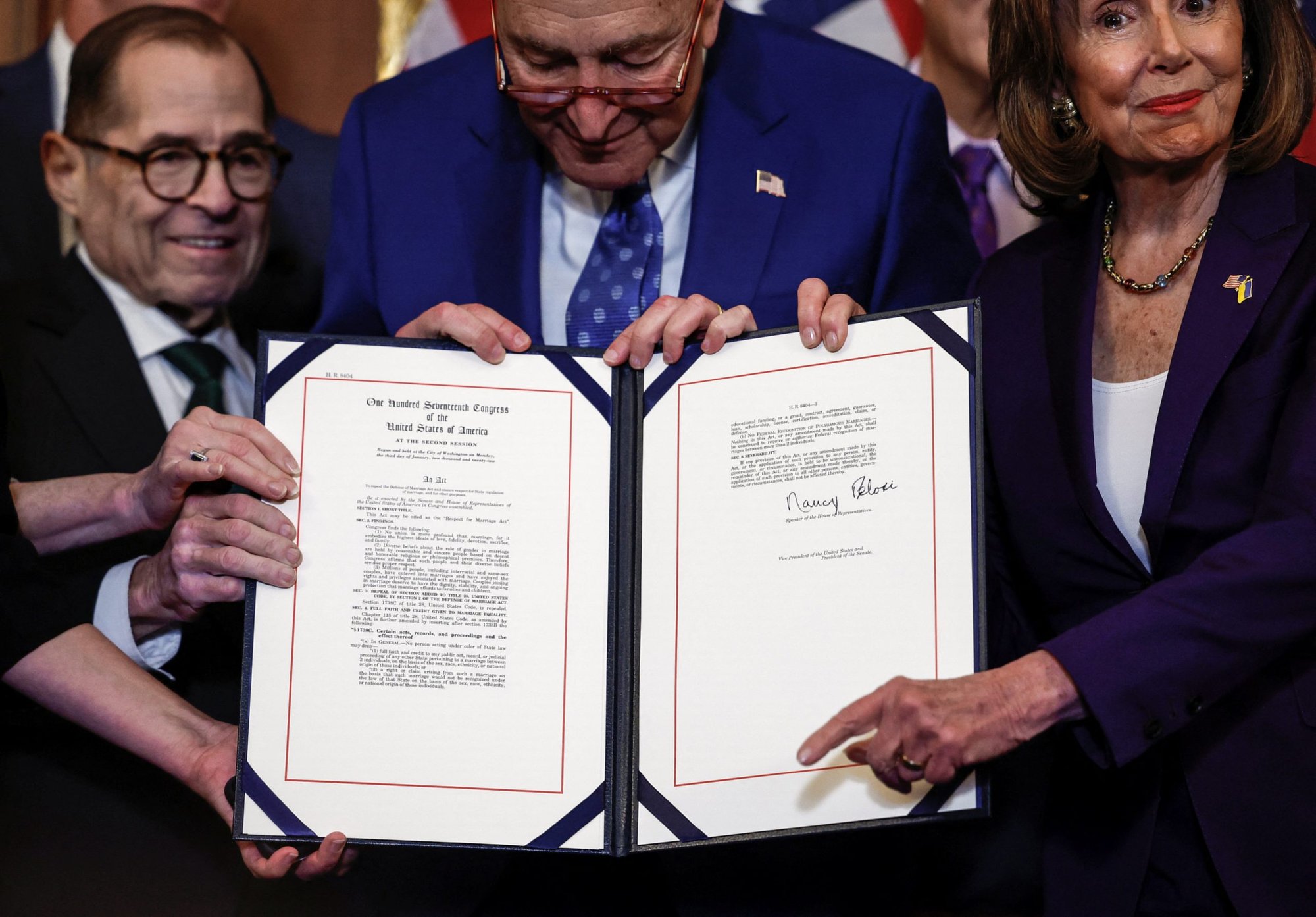 Rep. Jerry Nadler D-N.Y., left, Senate Majority Leader Chuck Schumer, D-N.Y., and House Speaker Nancy Pelosi, D-Calif., hold the Respect for Marriage Act during a bill enrollment ceremony on Capitol Hill in Washington Dec. 8, 2022. (CNS photo/Evelyn Hockstein, Reuters)