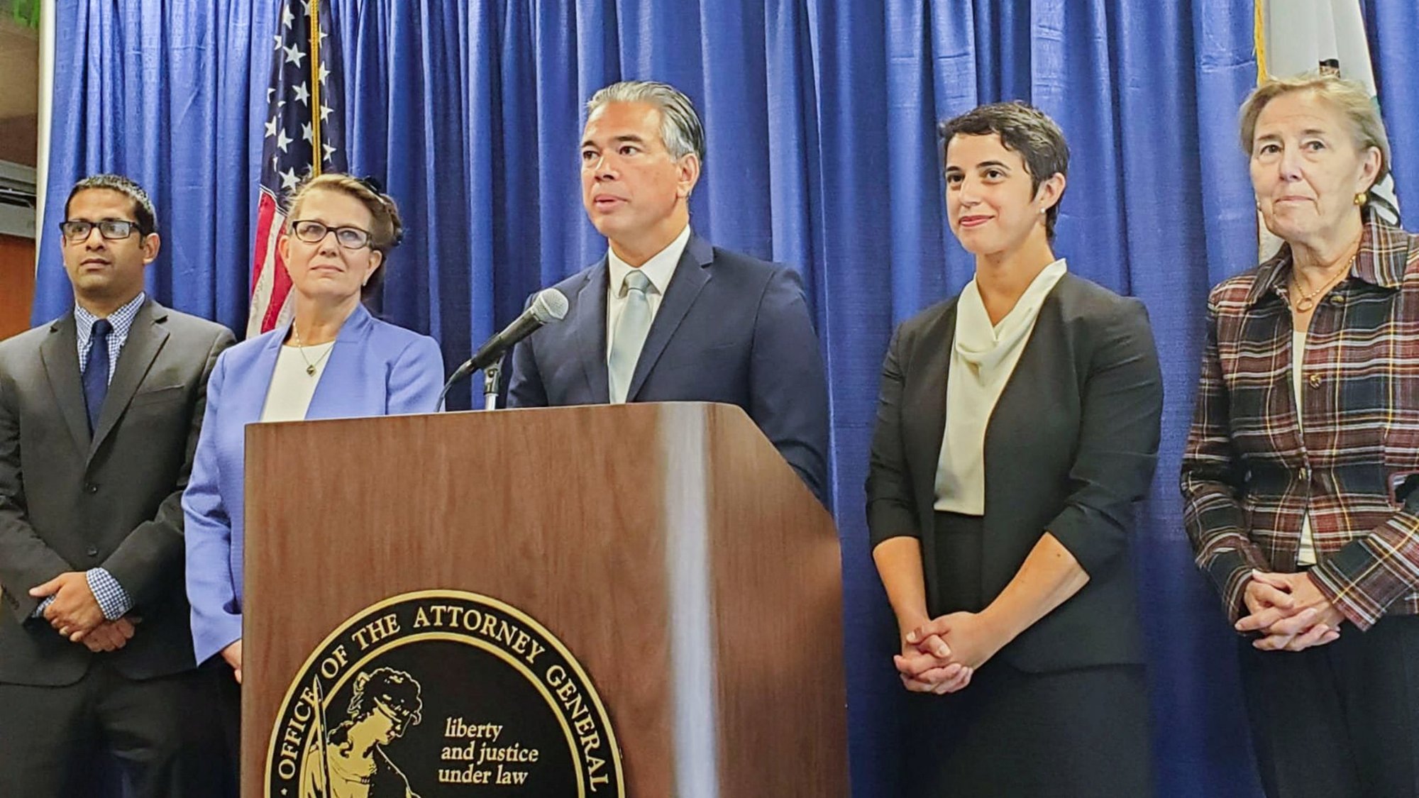 California Attorney General Rob Bonta, at lectern and flanked by staff in a file photo from Sept. 14, 2022. On Aug. 28, 2023 Bonta announced that the state is bringing suit to stop a San Bernardino school district from carrying out a policy of informing parents when their child requests to change their gender and pronouns. (OSV News photo/Paresh Dave, Reuters)