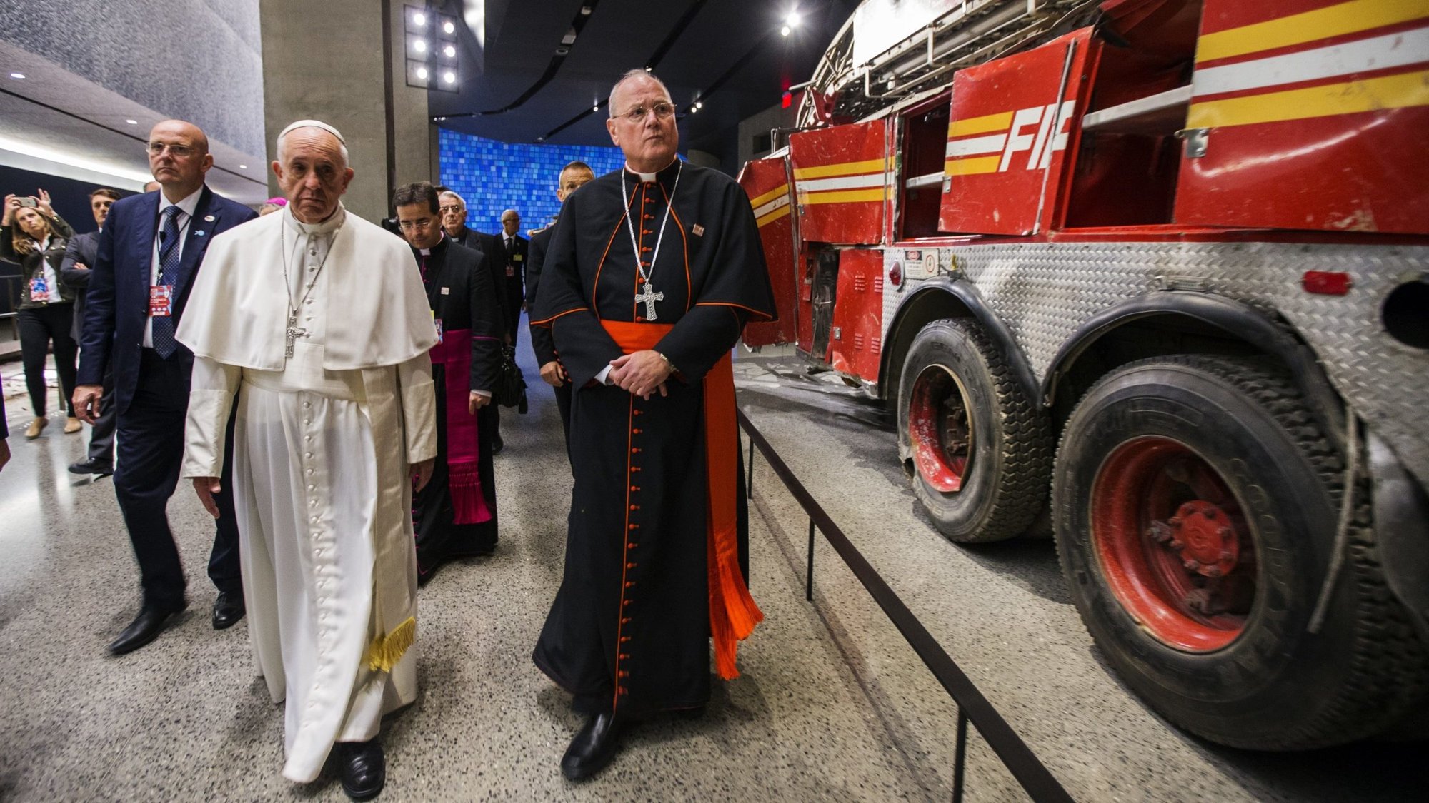 Pope Francis walks with Cardinal Timothy M. Dolan of New York as they pass a firetruck from Ladder Company 3 at the 9/11 Memorial and Museum in New York Sept. 25, 2015. (CNS/Jin Lee, pool)